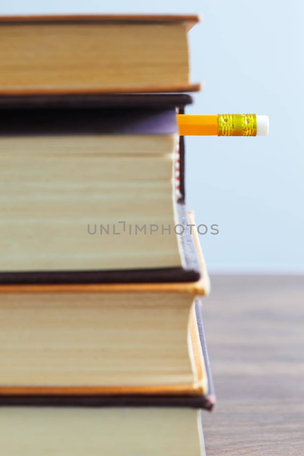 pile of books and pencil on desk. Selective focus