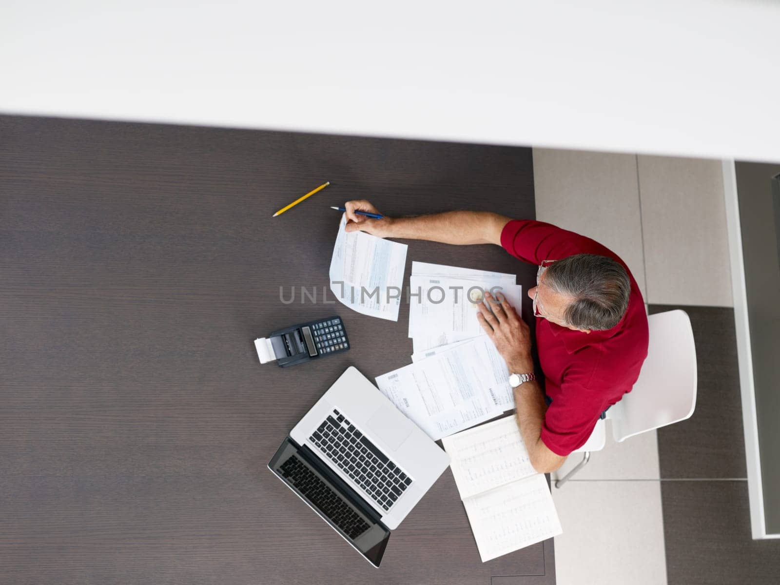 Senior man checking home finances. High angle view, copy space