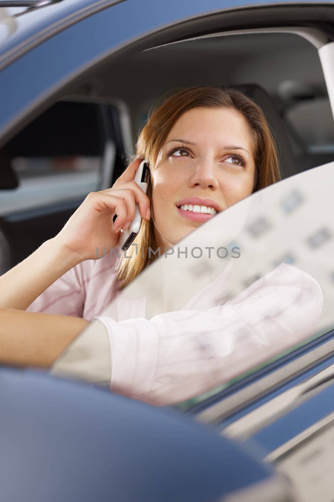 woman driving car and talking on mobile phone.
