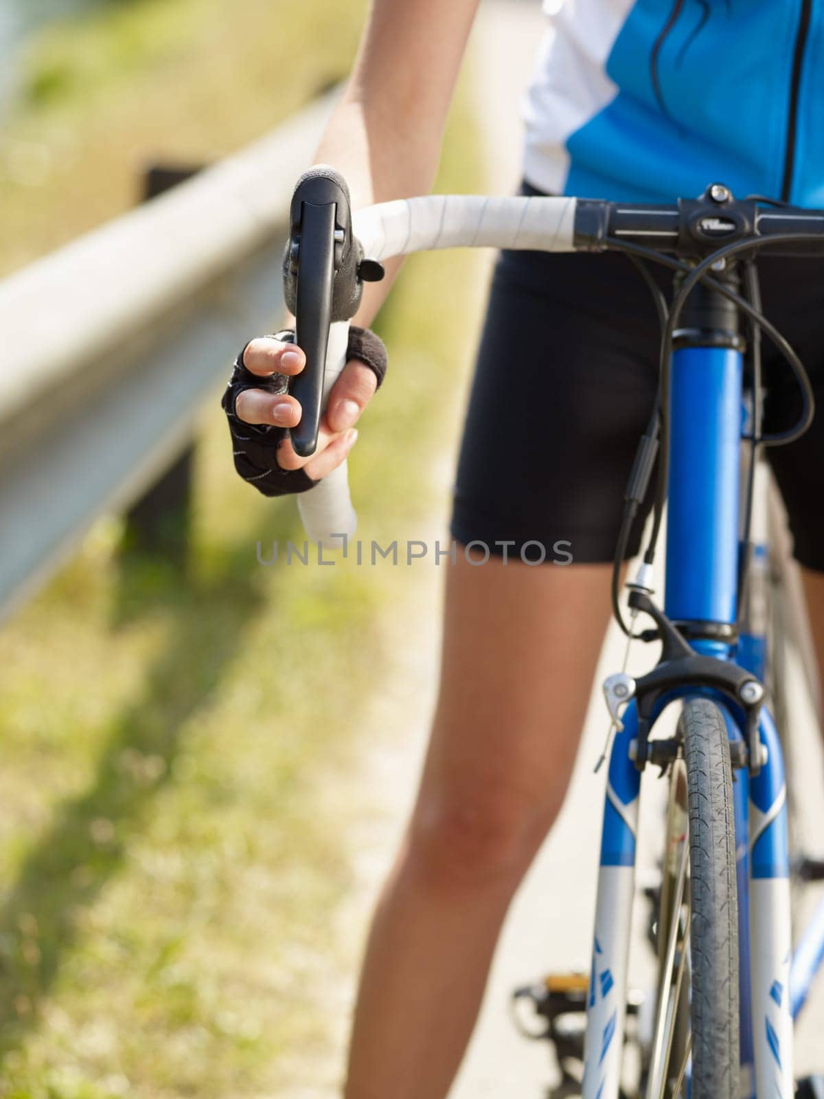 Cropped view of female cyclist with hands on brakes. Copy space