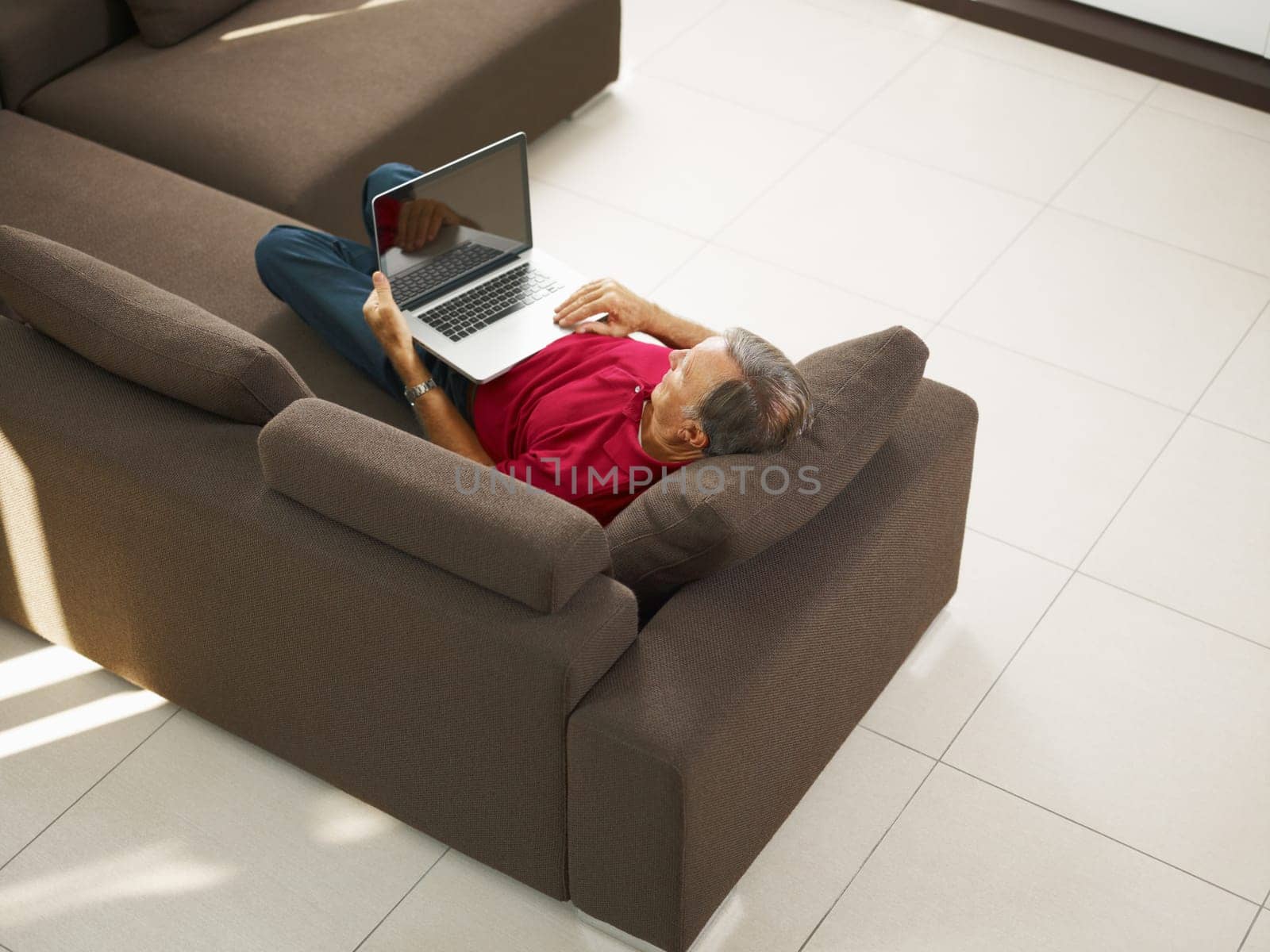 Senior man using laptop computer at home. High angle view, Copy space
