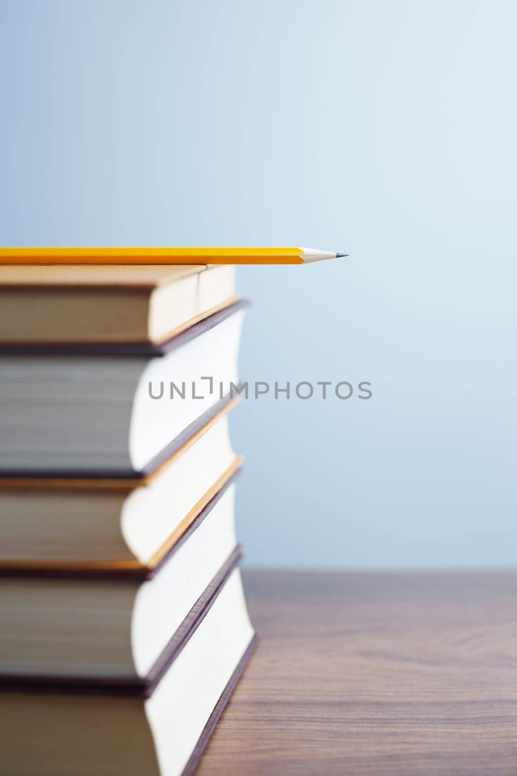 pile of books and pencil on desk. Selective focus, copy space