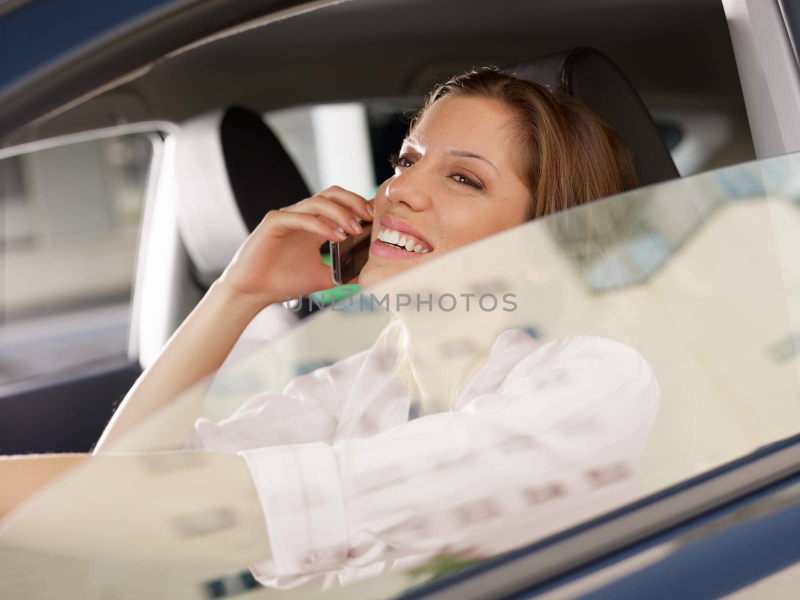 woman driving car and talking on mobile phone.