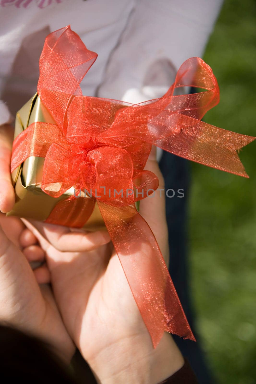 close up shot of hands and yellow giftb