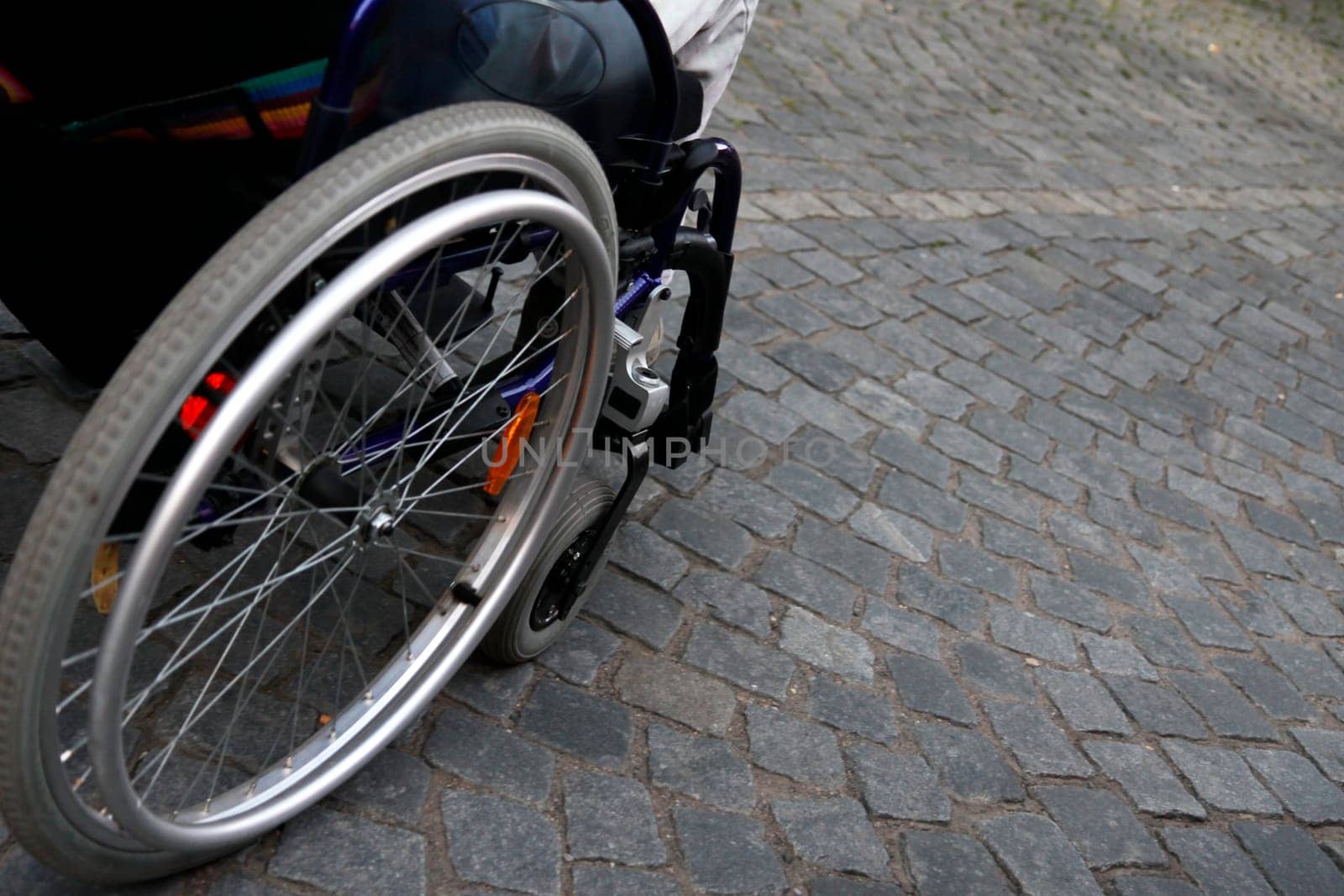 detail wheelchair on cobblestones
