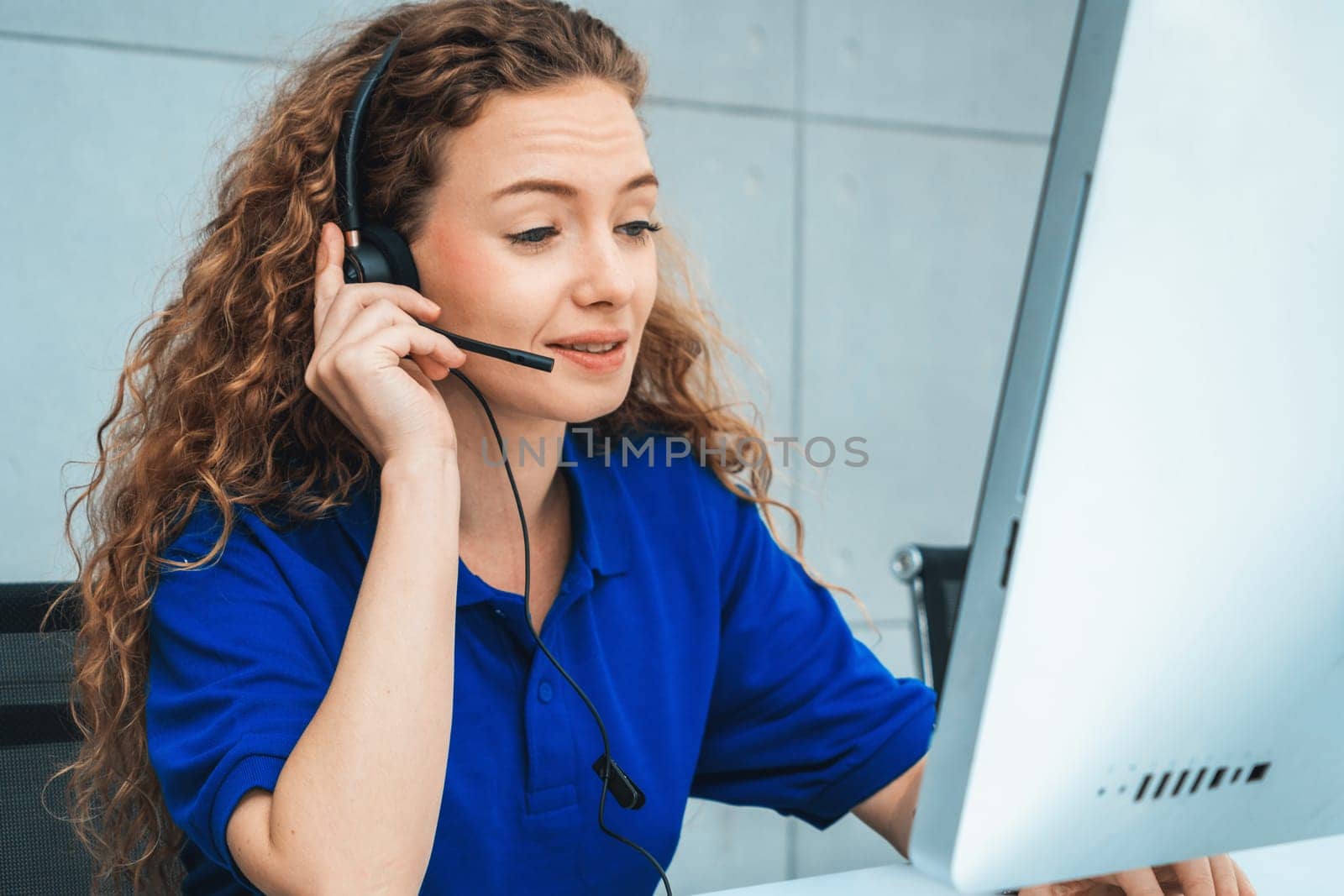 Business people wearing headset working in office to support remote customer or colleague. Call center, telemarketing, customer support agent provide service on telephone video conference call. Jivy