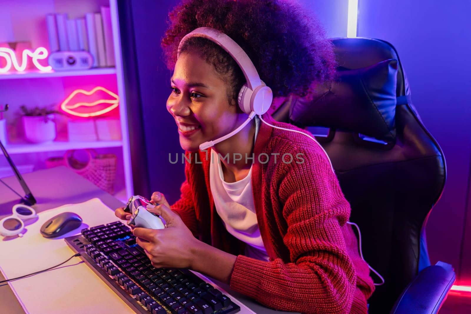 Host channel of gaming streamer, African girl wining with Esport skilled team player and viewers online game in neon color lighting room. Concept of cybersport indoor activities. Tastemaker.