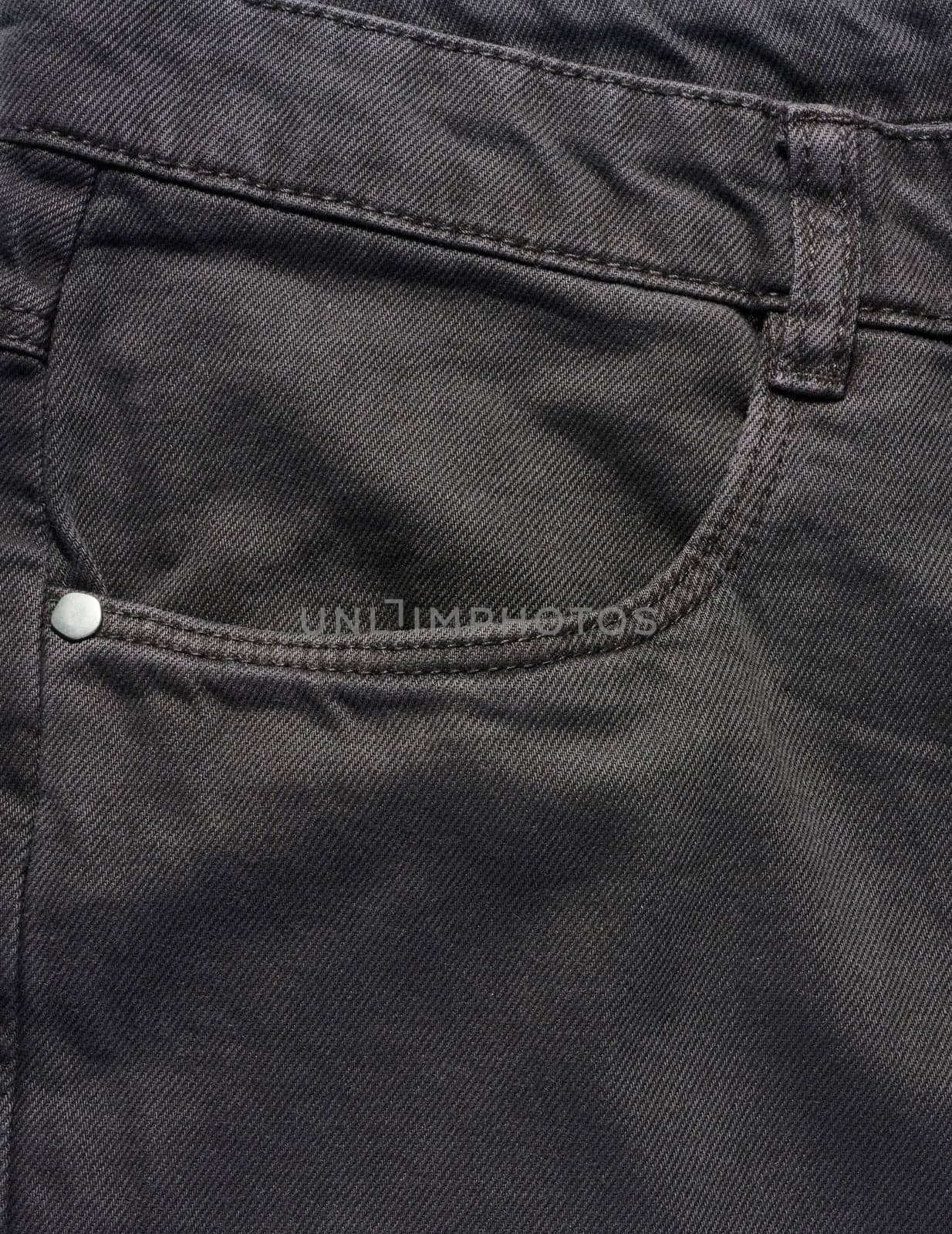 Black jeans front pocket with buttons, close up by ndanko