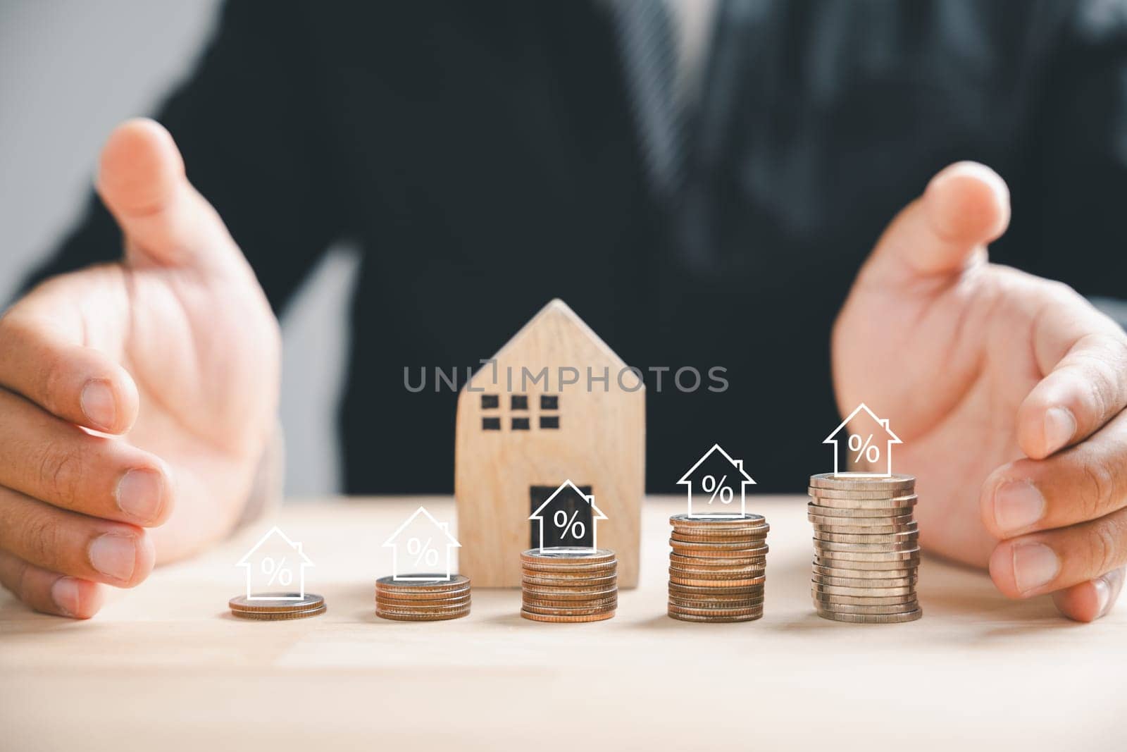 Businessman with house wooden and coin stack, real estate profit plan by Sorapop