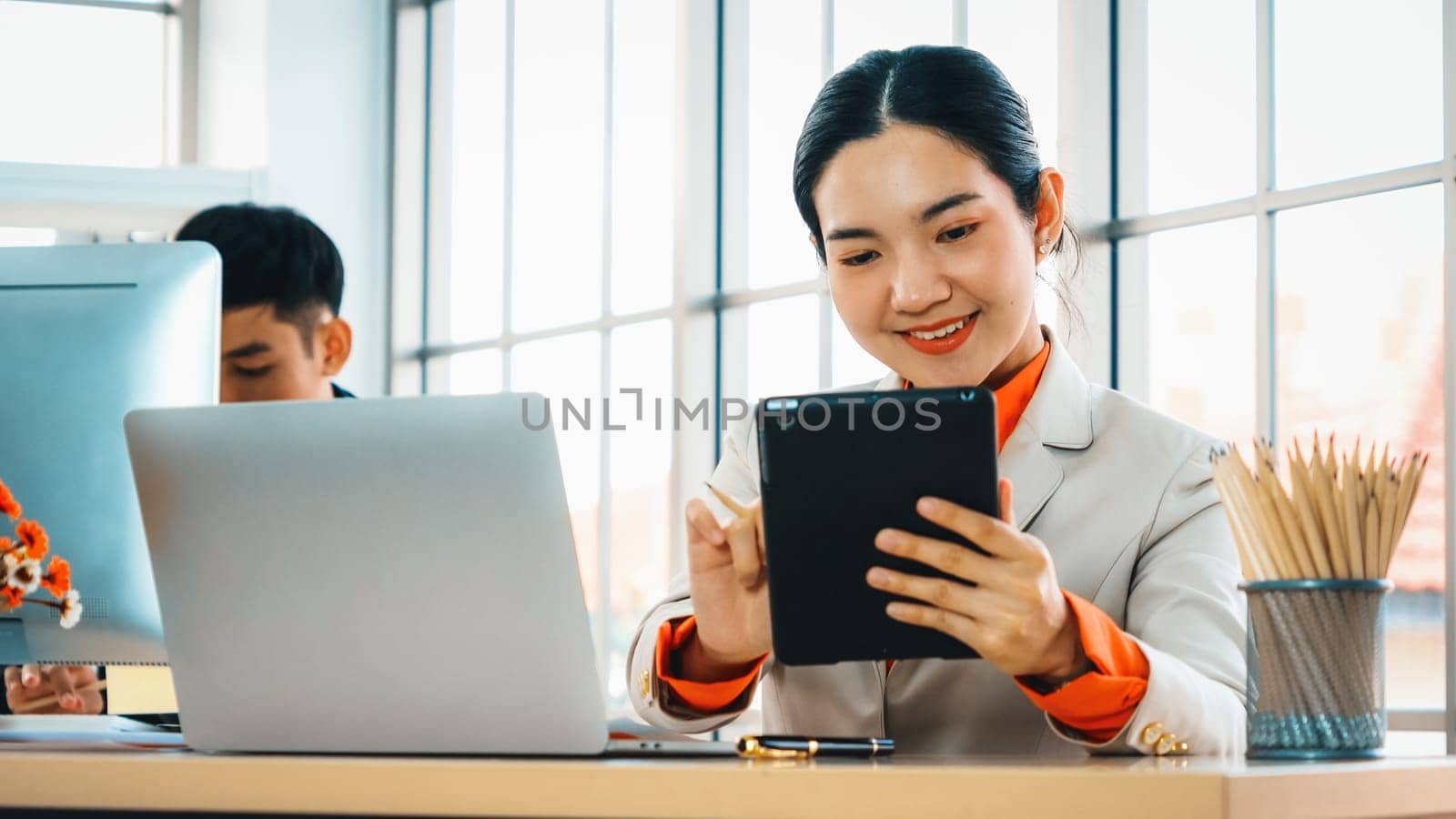 Business people working at table in modern office room while analyzing financial data report . Jivy