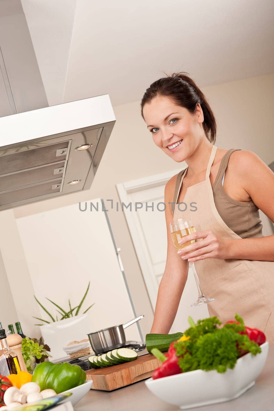 Young smiling woman with groceries in the kitchen