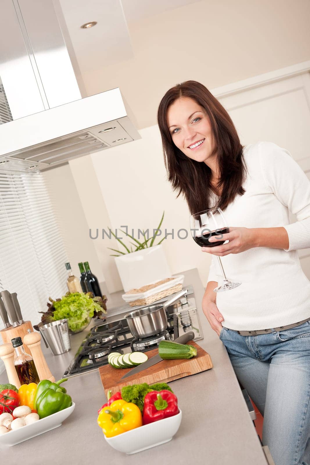 Young smiling woman with groceries in the kitchen