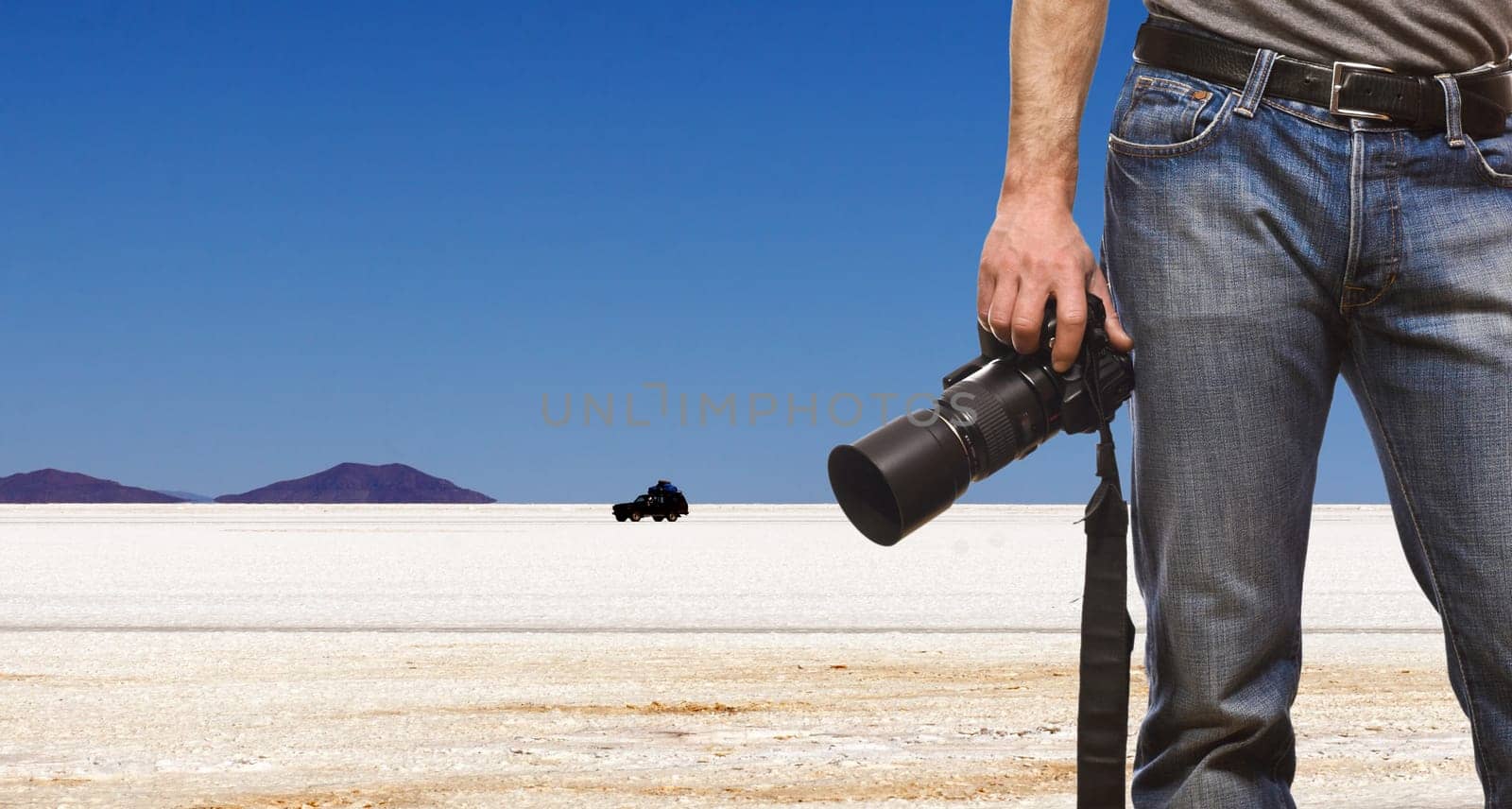 detail of photographer and desert landscape background