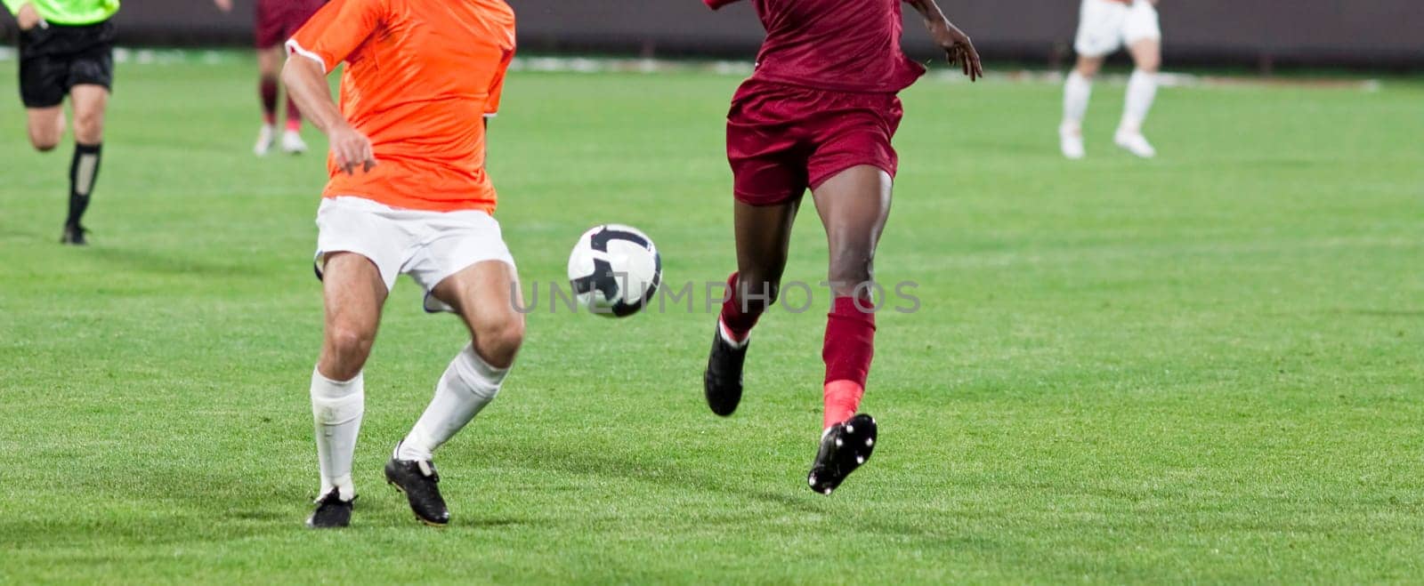 Soccer players fighting for the ball