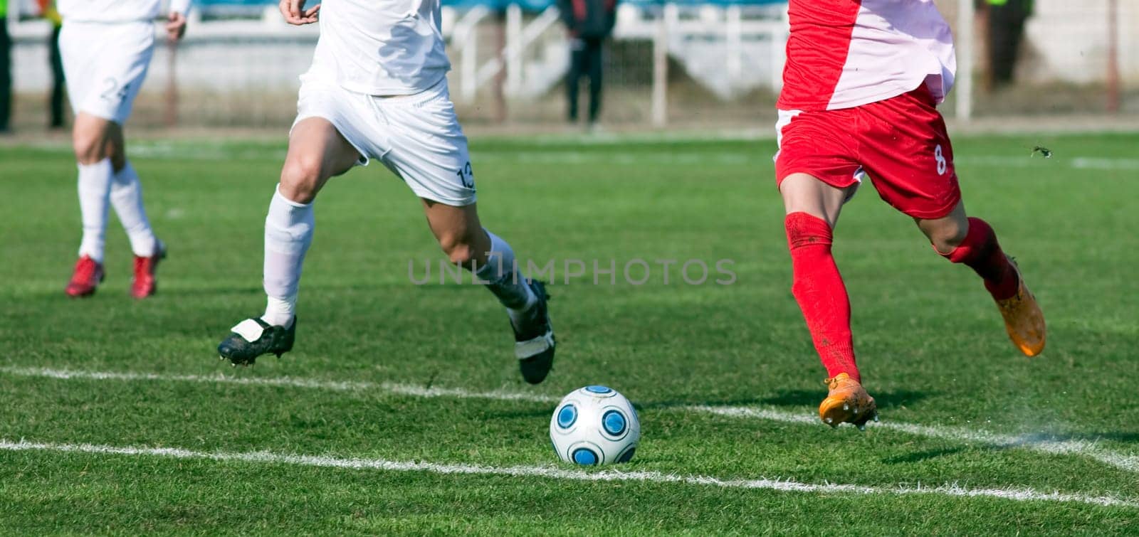 Soccer players fighting for the ball
