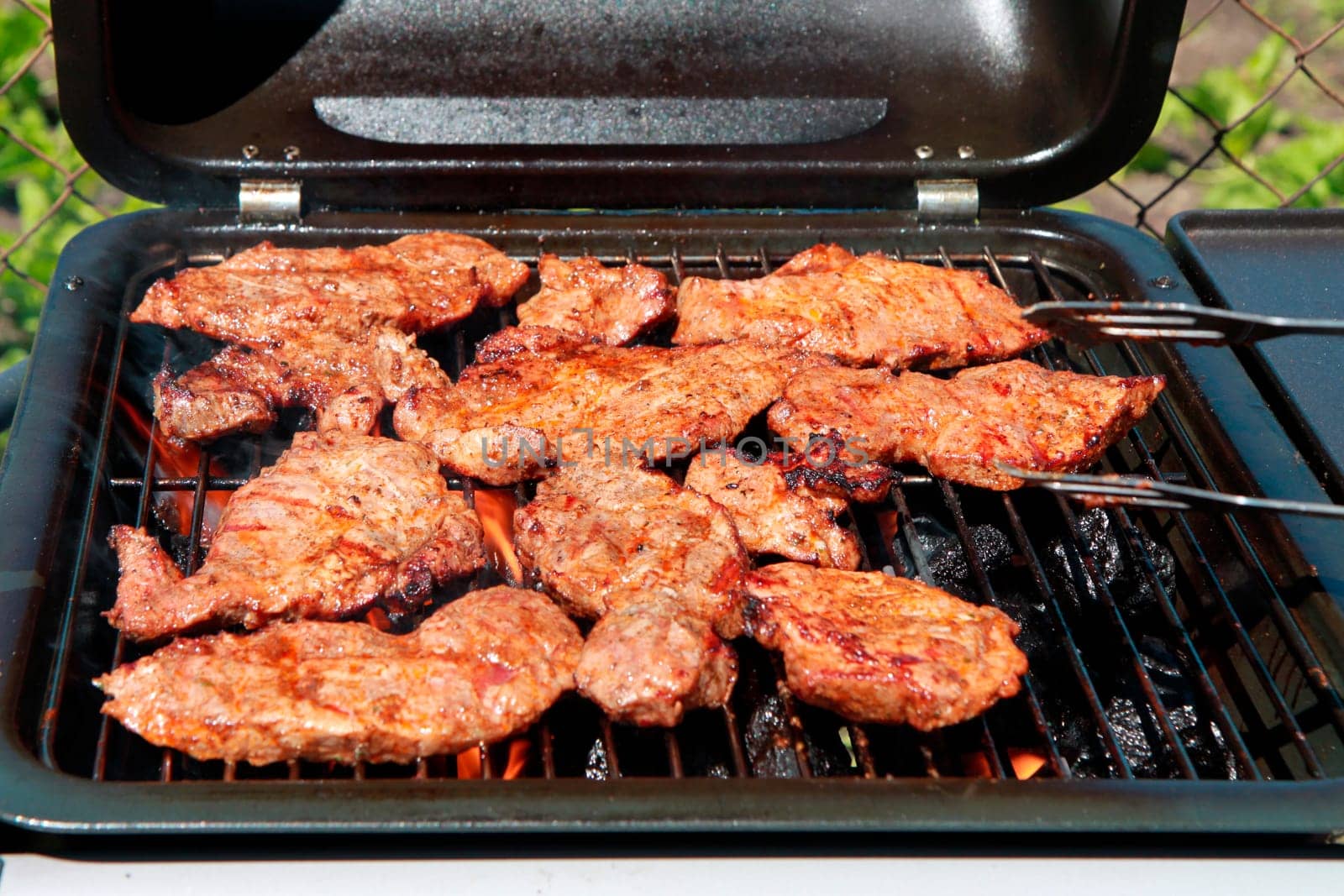 outdoor grilled pig meat on grill