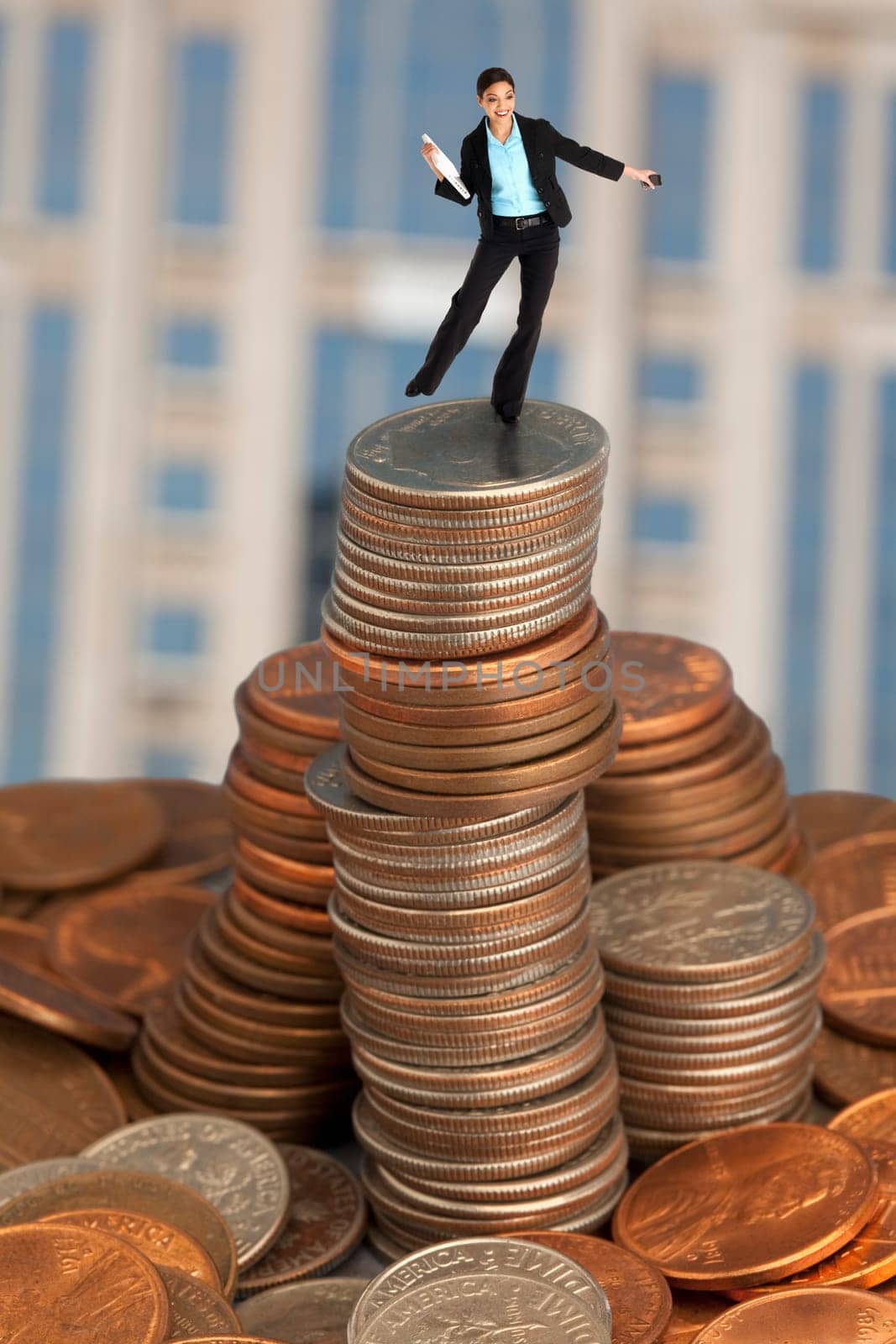 Businesswoman balancing on coins