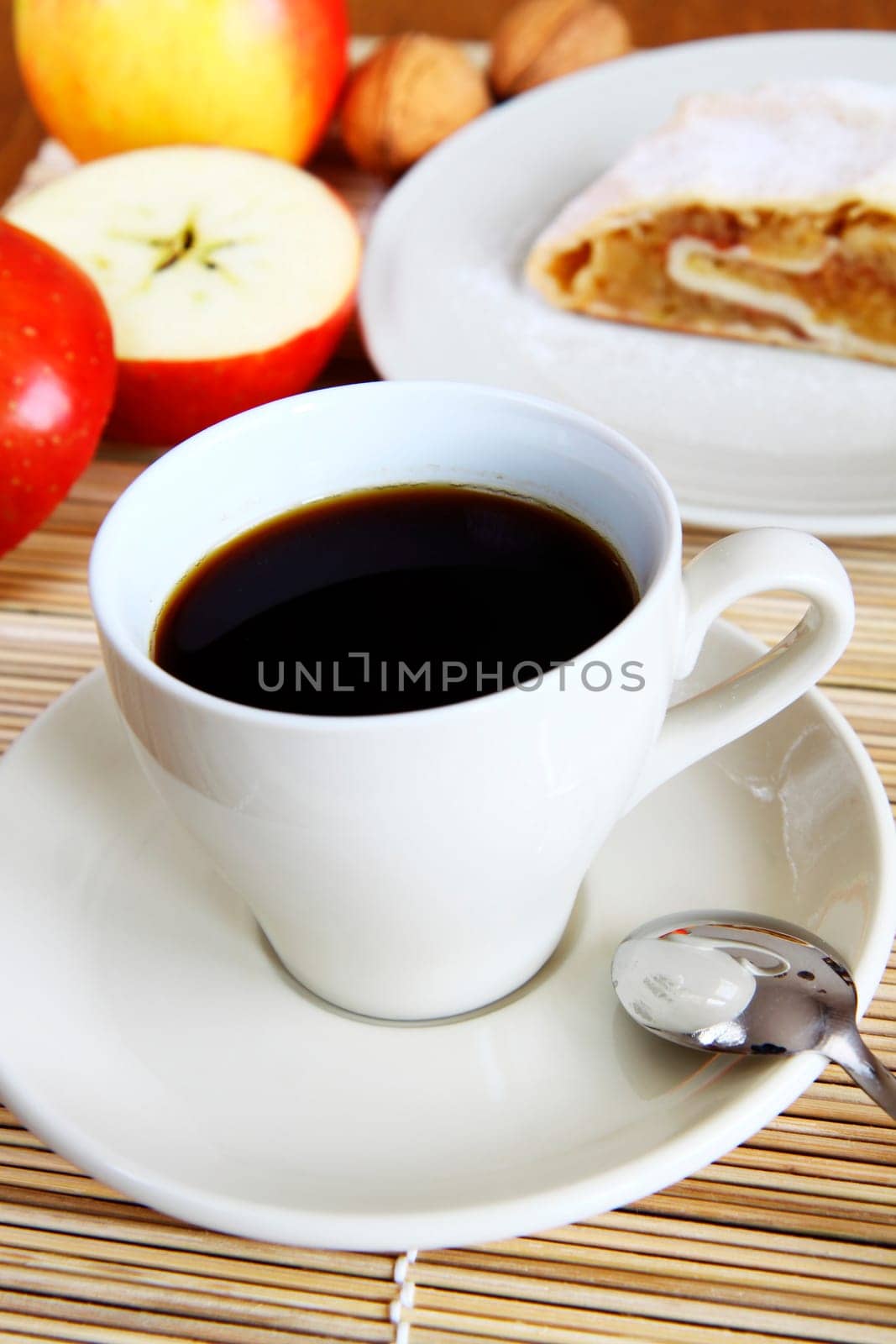 cup of coffee in white porcelain with apple strudel