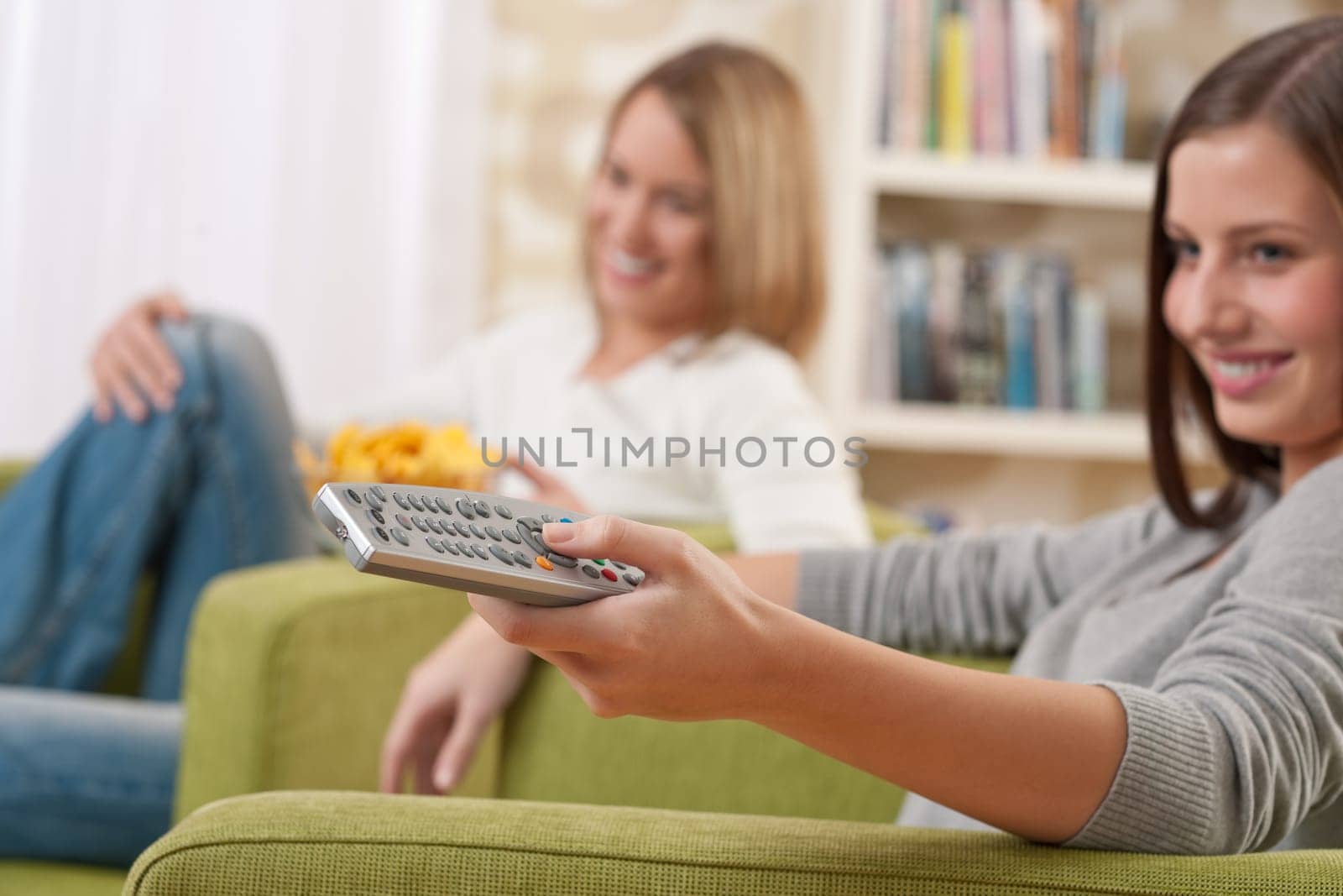 Two female students watching television