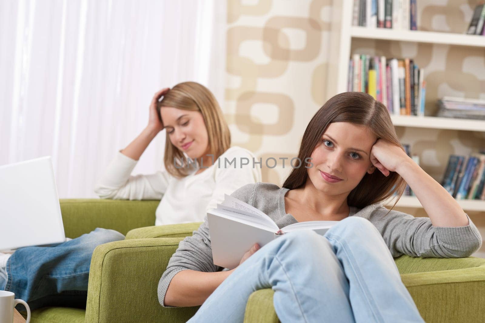 Two female students relaxing in lounge