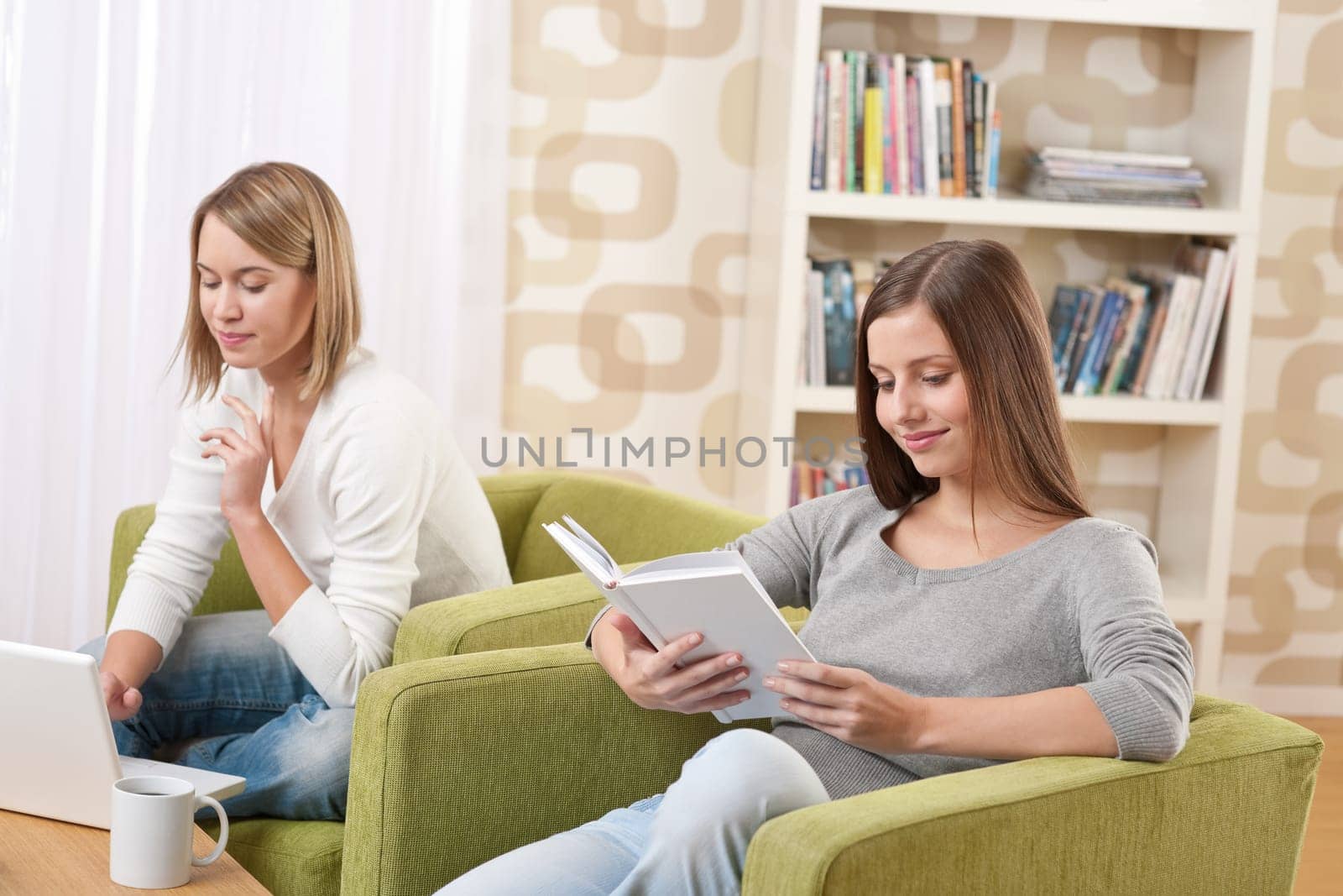 Two female students relaxing in lounge