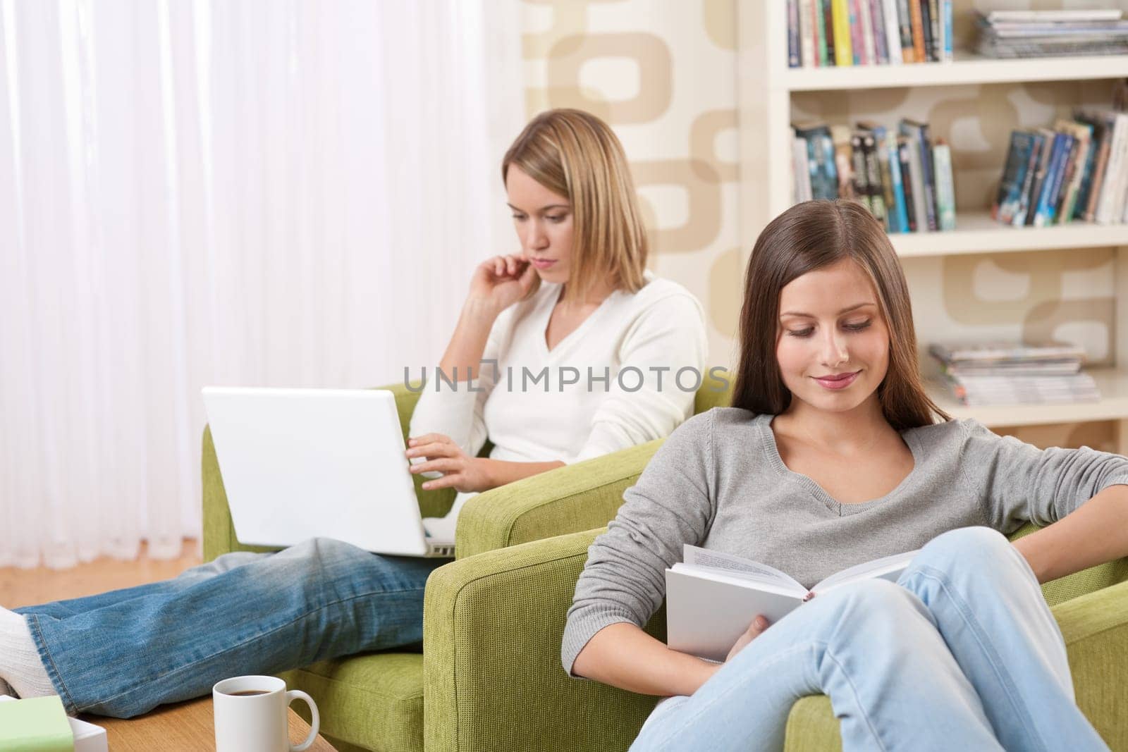 Two female students relaxing in lounge