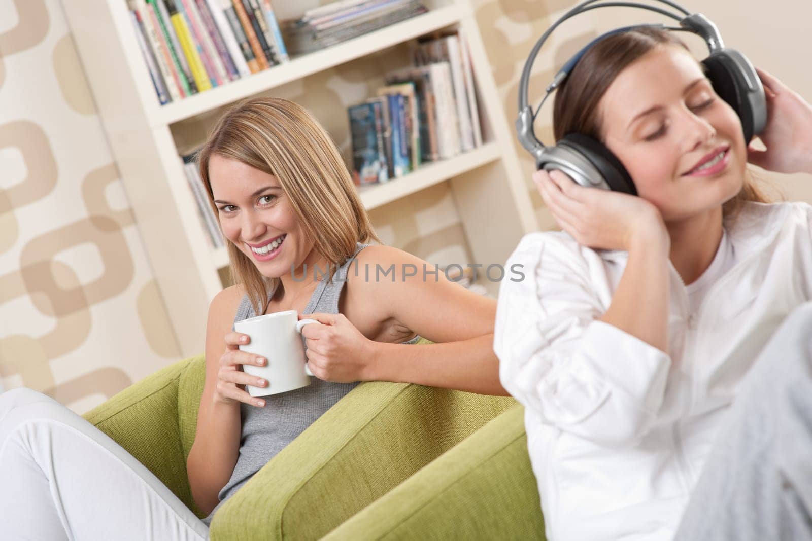 Two female students relaxing home