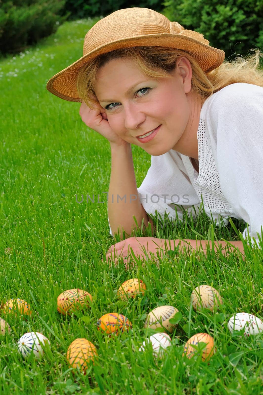 Young woman and easter eggs on grass - Easter time
