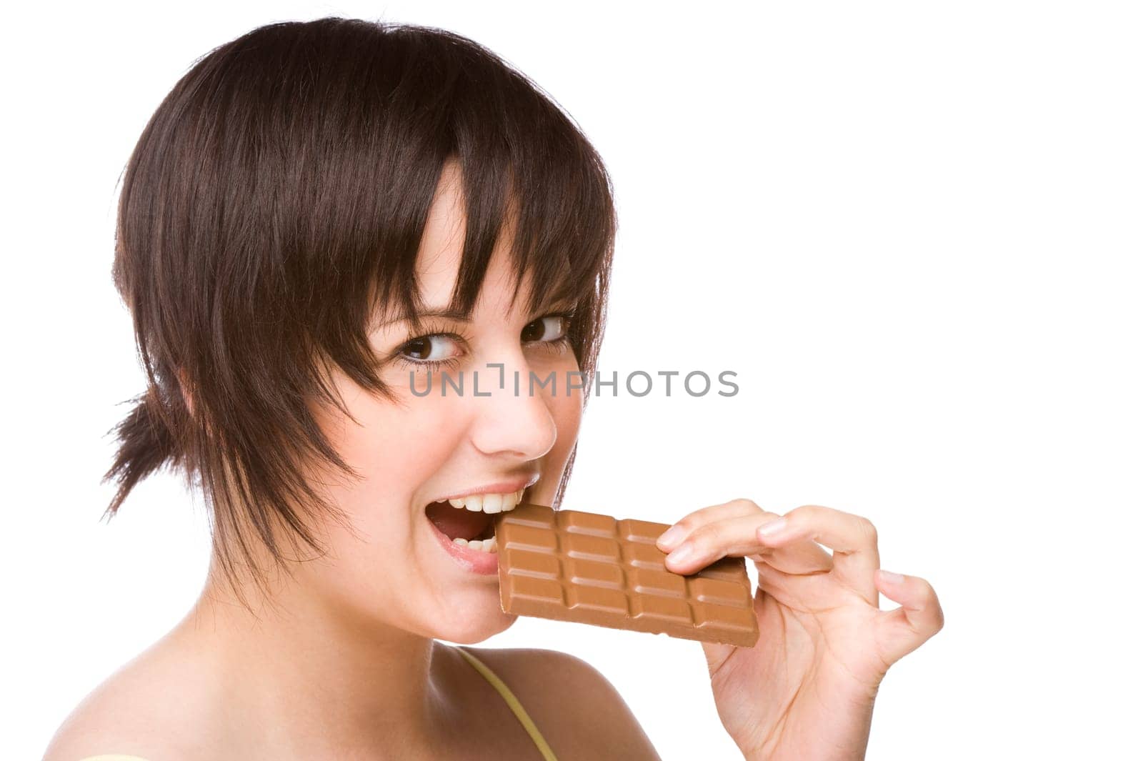 Young woman biting into a piece of chocolate