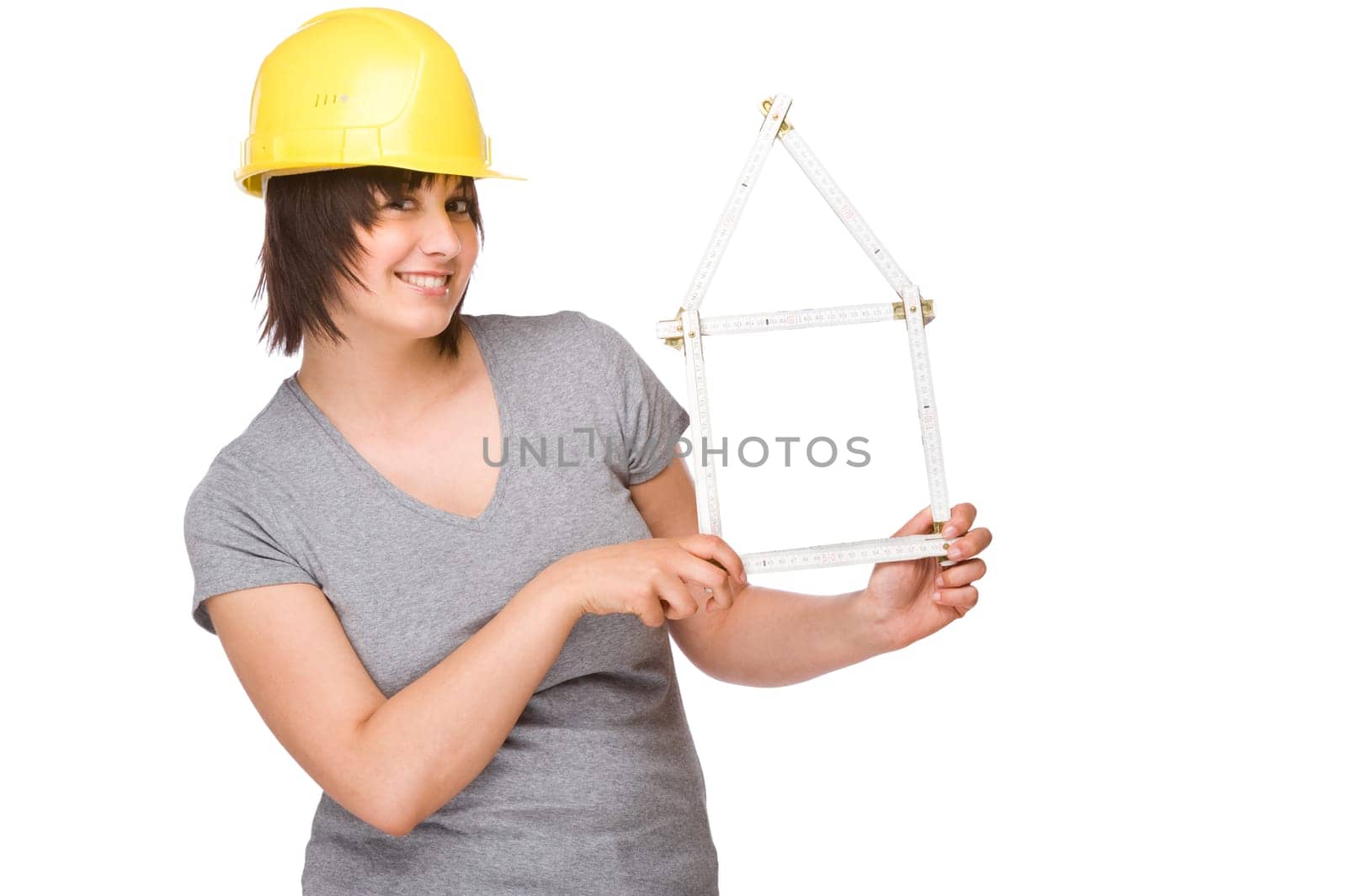 Young woman with a construction helmet and a folding rule