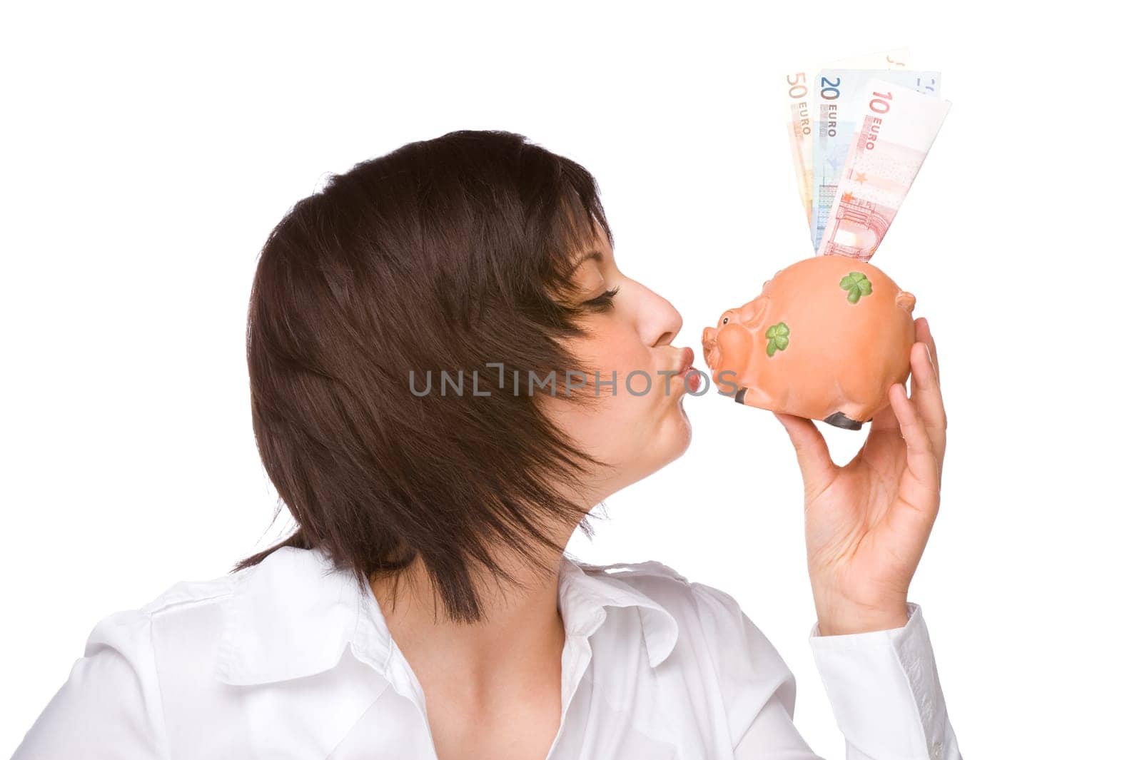 Young woman kissing a piggy bank