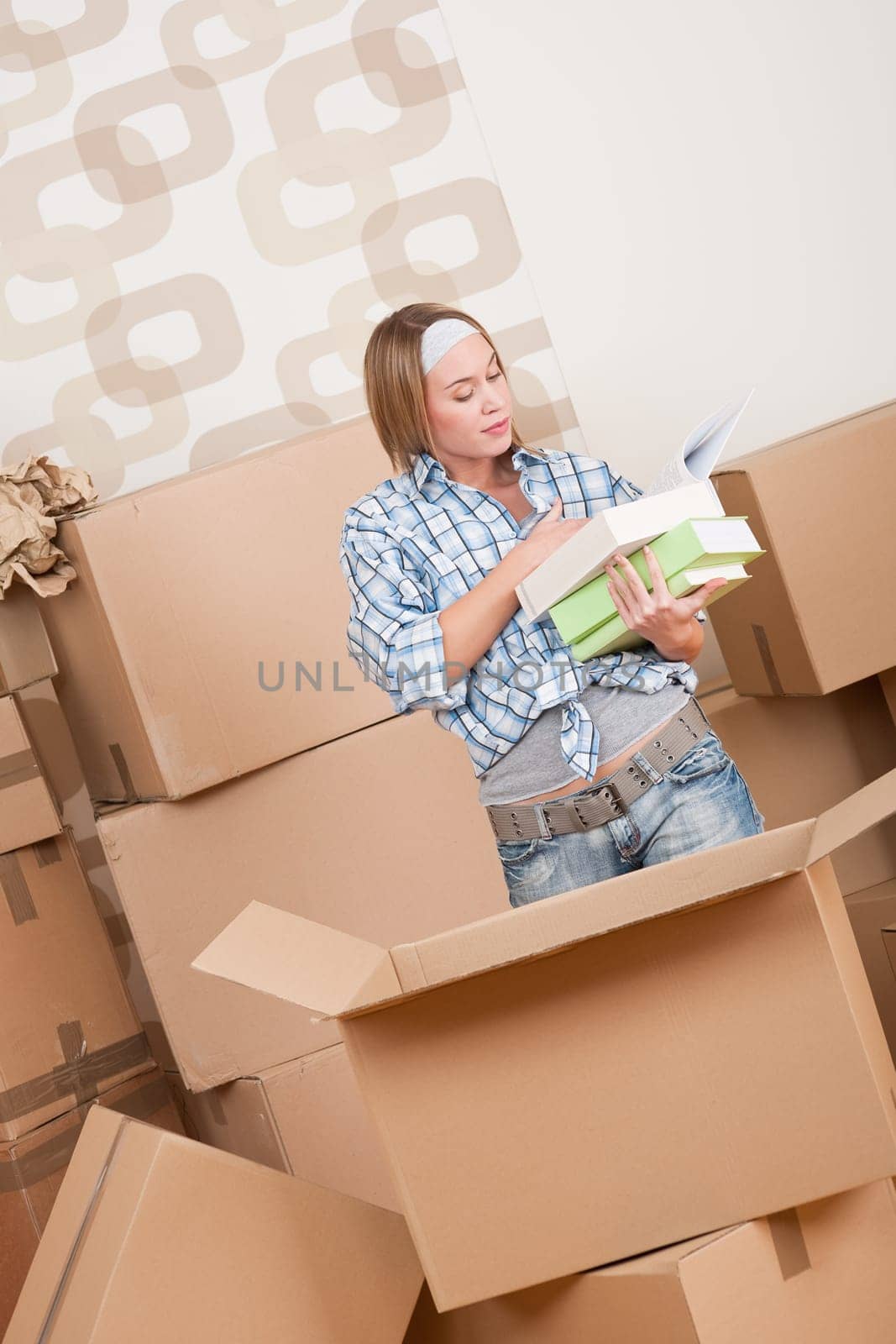 Moving house Woman unpacking box