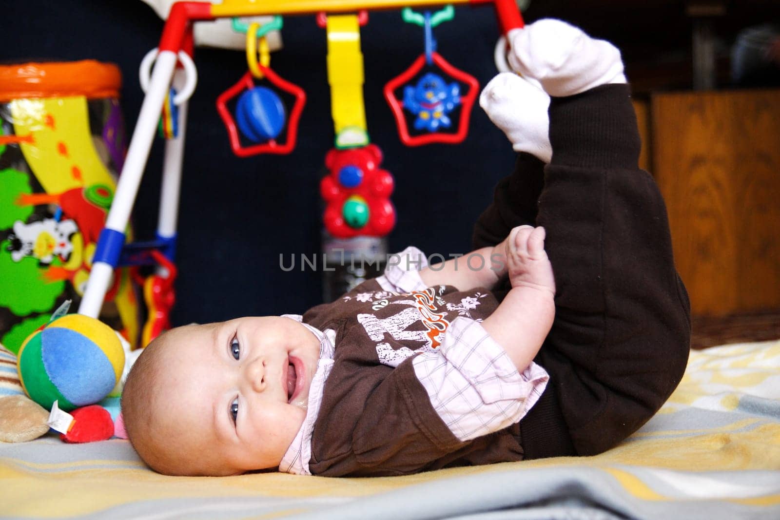 Baby lying on his back on play mat