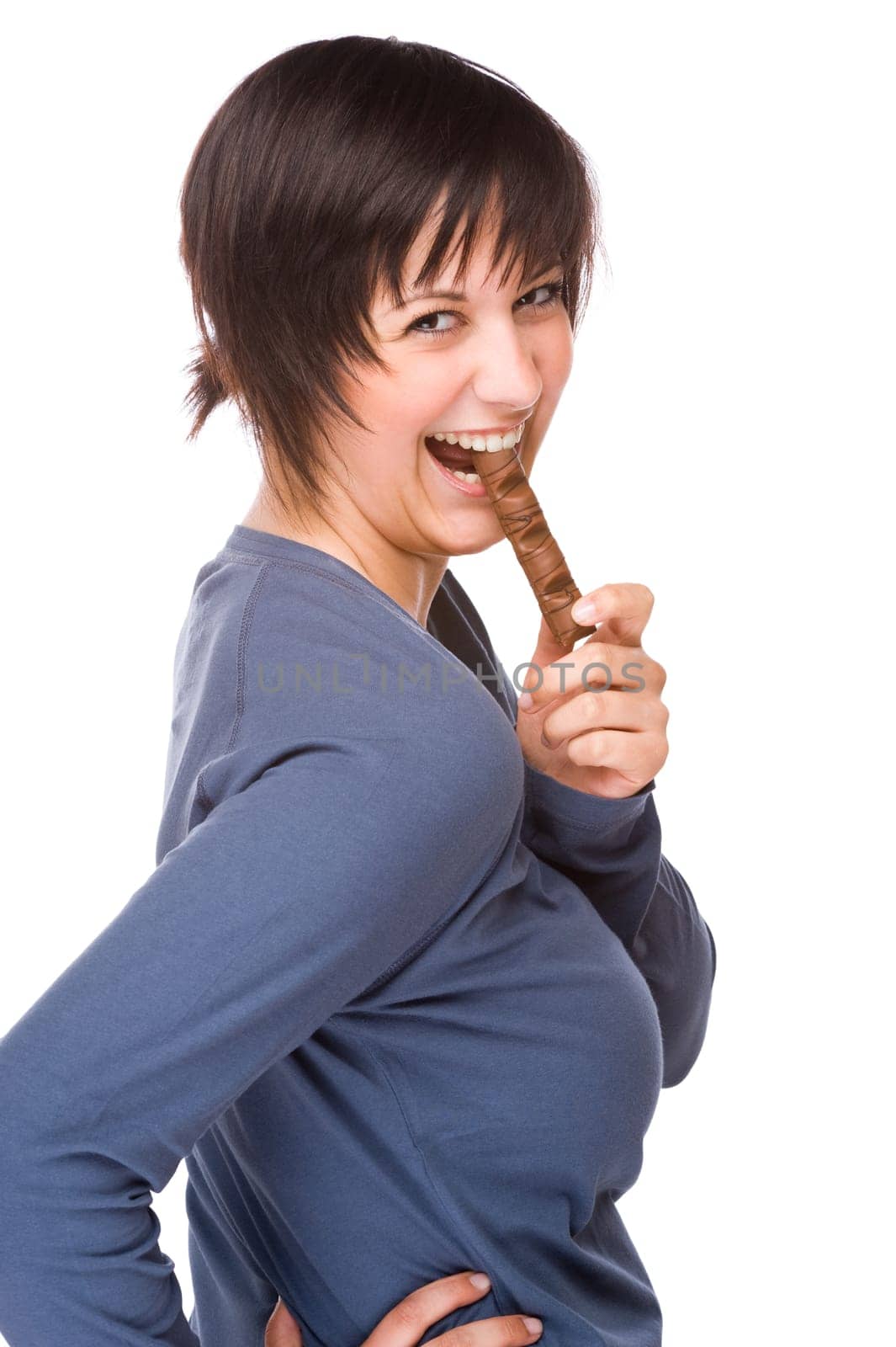 Young woman snacking on a chocolate bar.