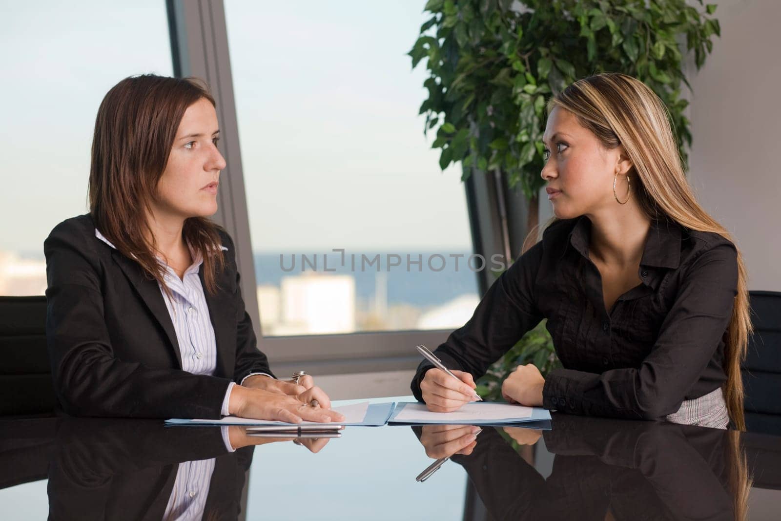 Two businesswomen looking at each other