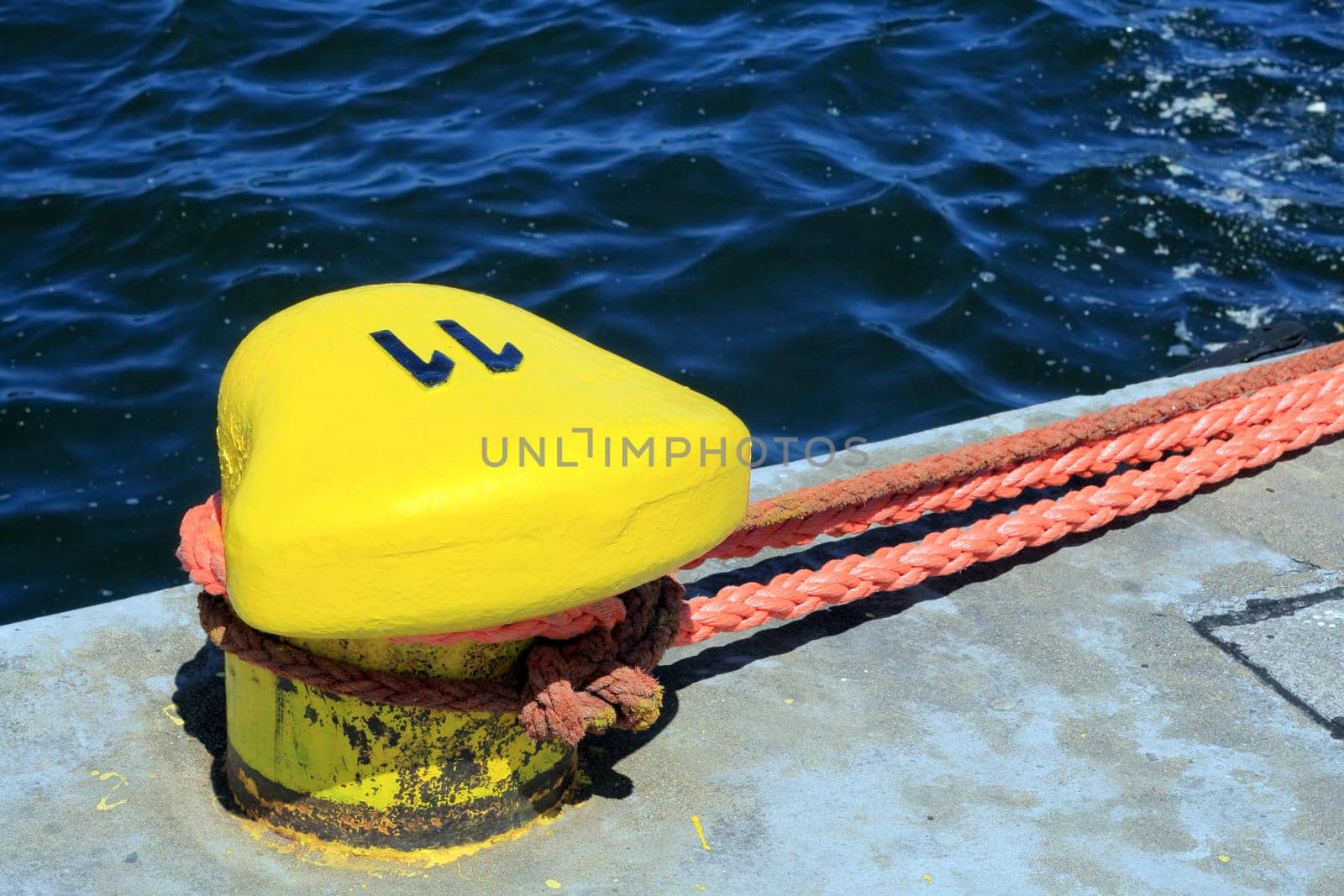 Yellow bollard on the quay