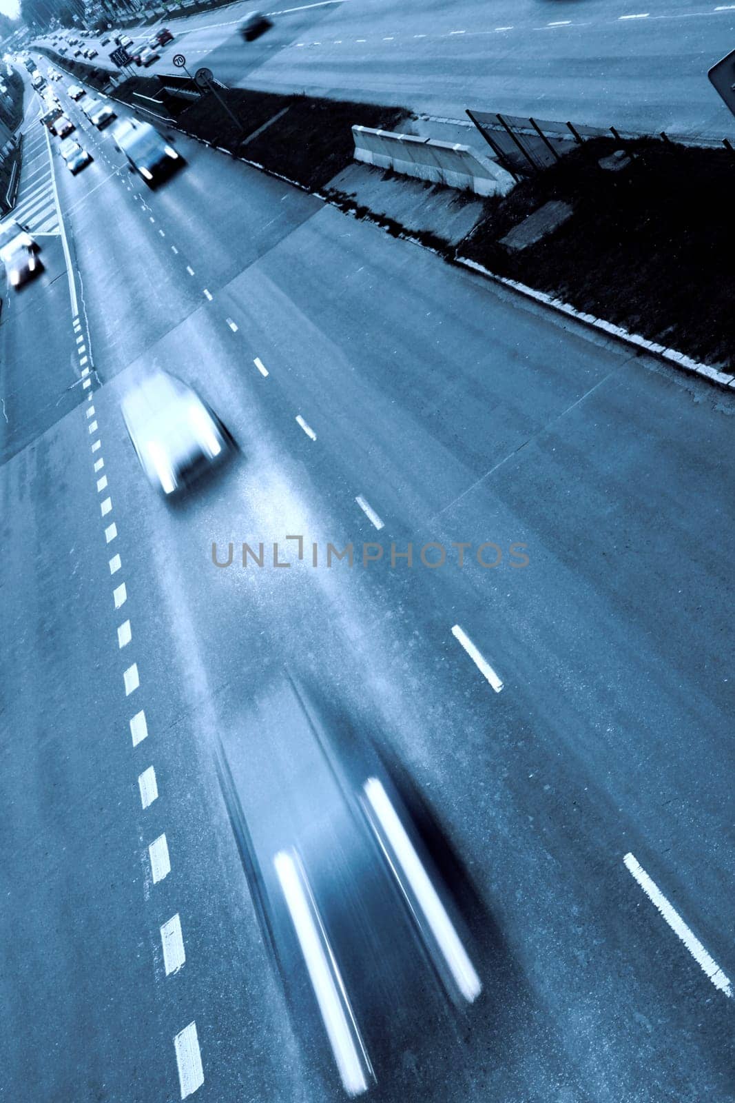 Highway with lots of cars. Blue tint, high contrast and motion blur to rise spee