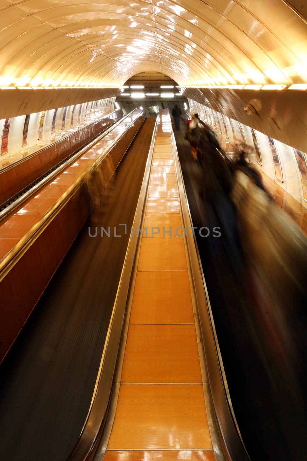 escalator with people in Prague underground - blurred foregrounding movement