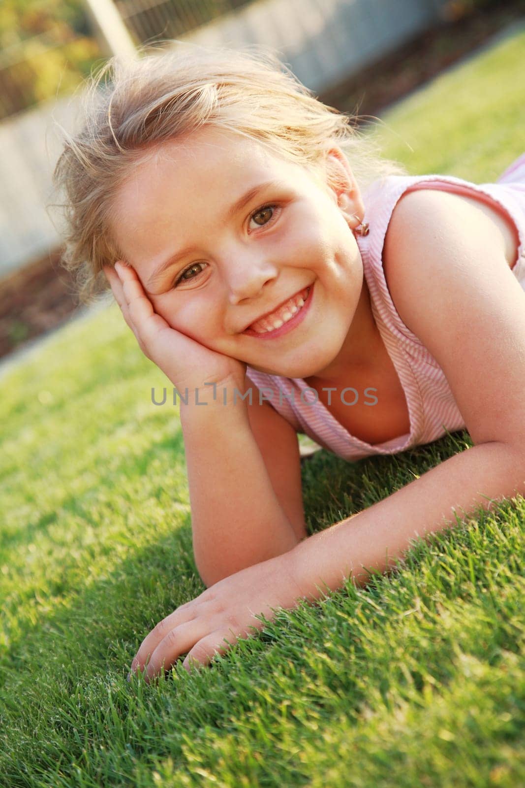 Happy girl relaxing on a grass
