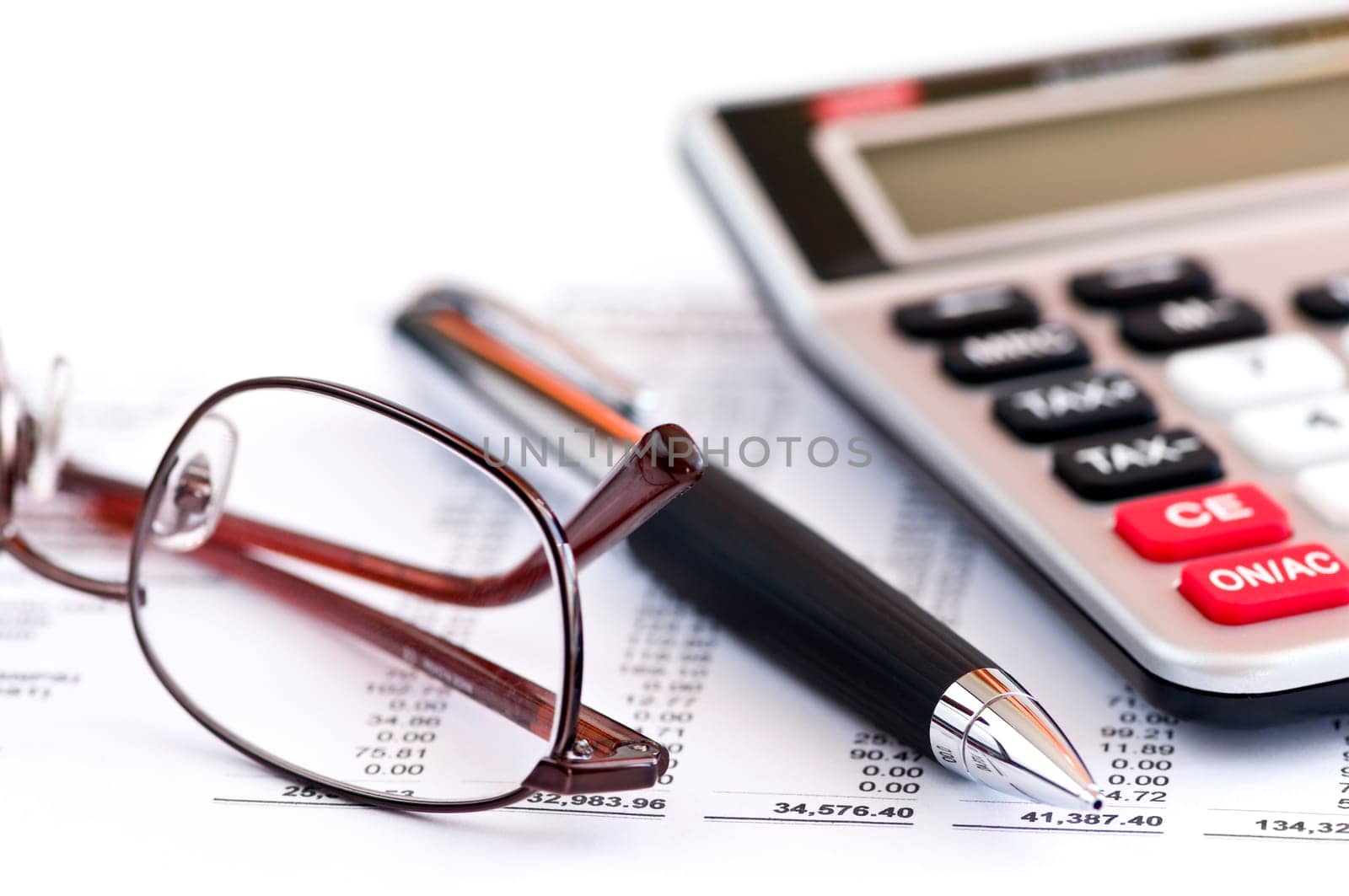 Tax calculator pen and glasses