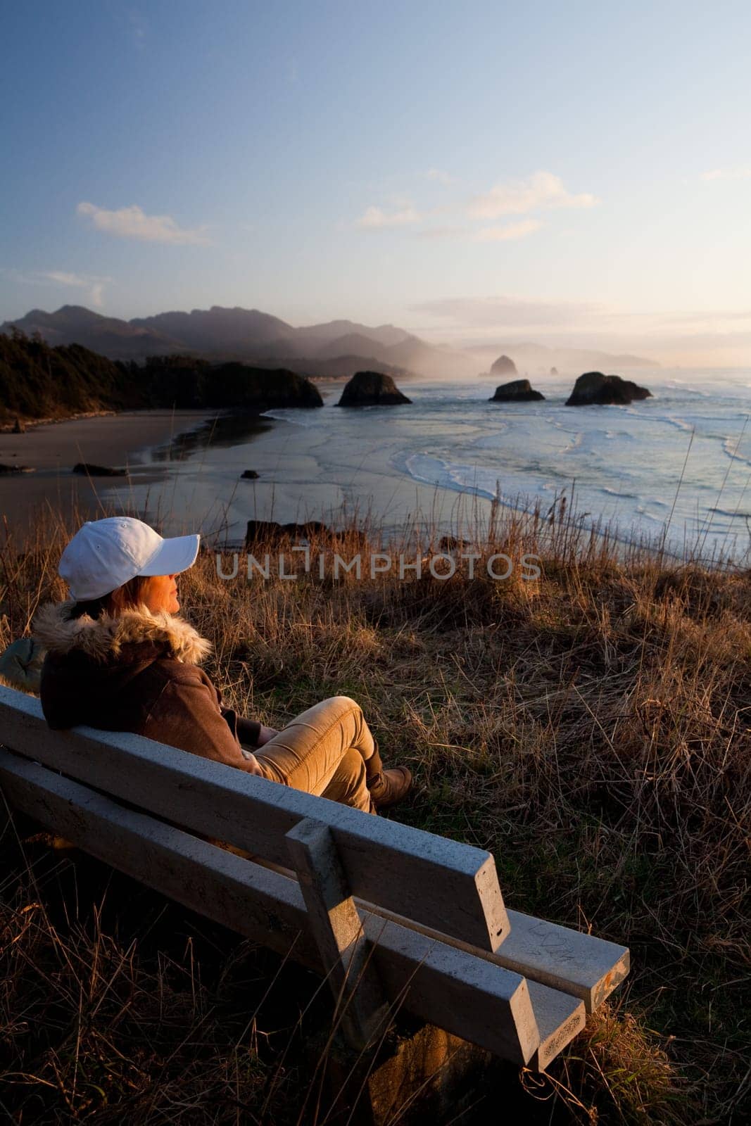 woman on bench overlooking beach