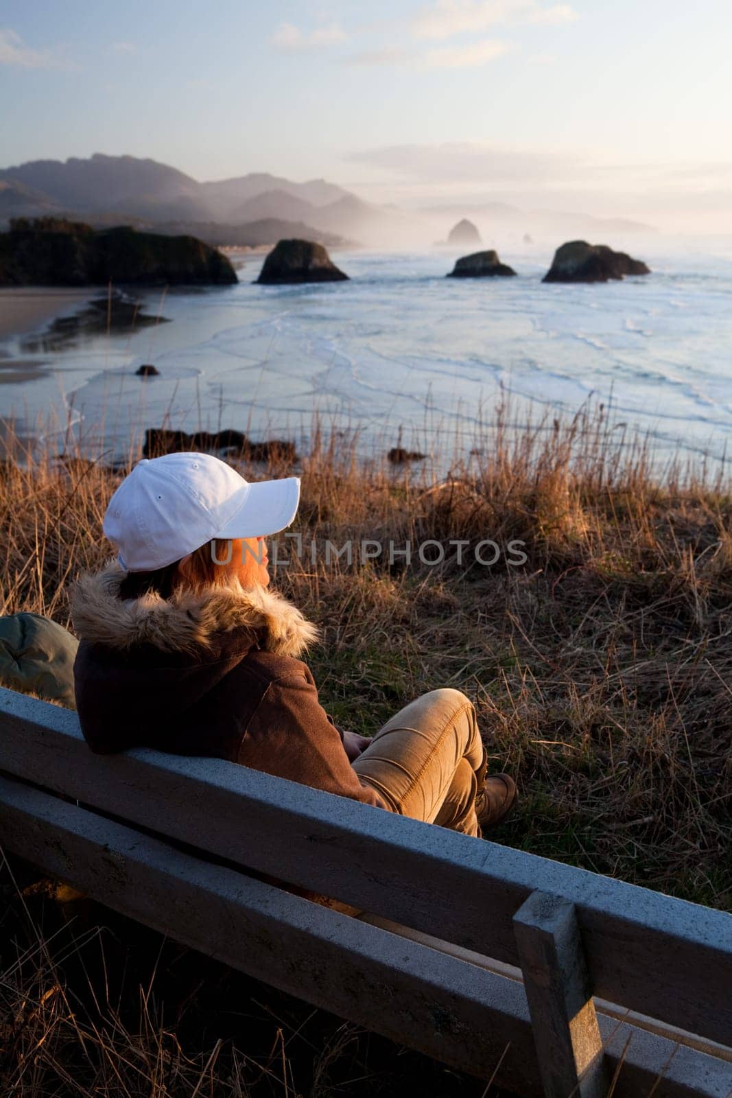 woman on bench overlooking Oregon coast