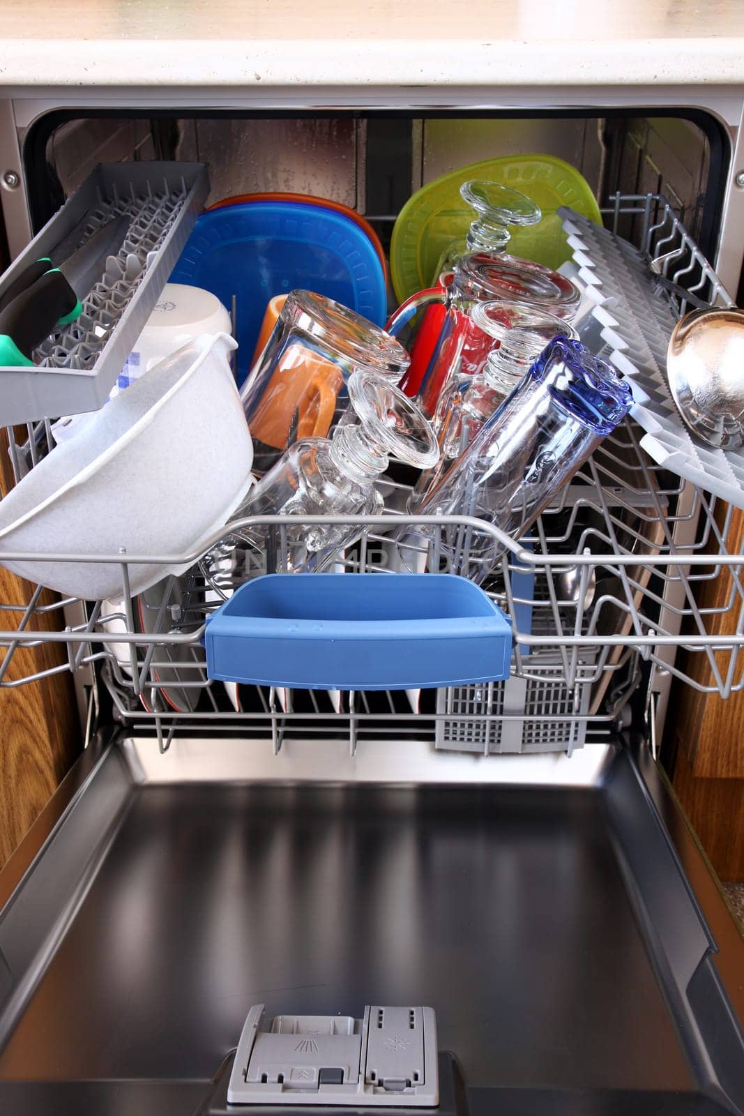 open dishwasher with clean dishes in kitchen