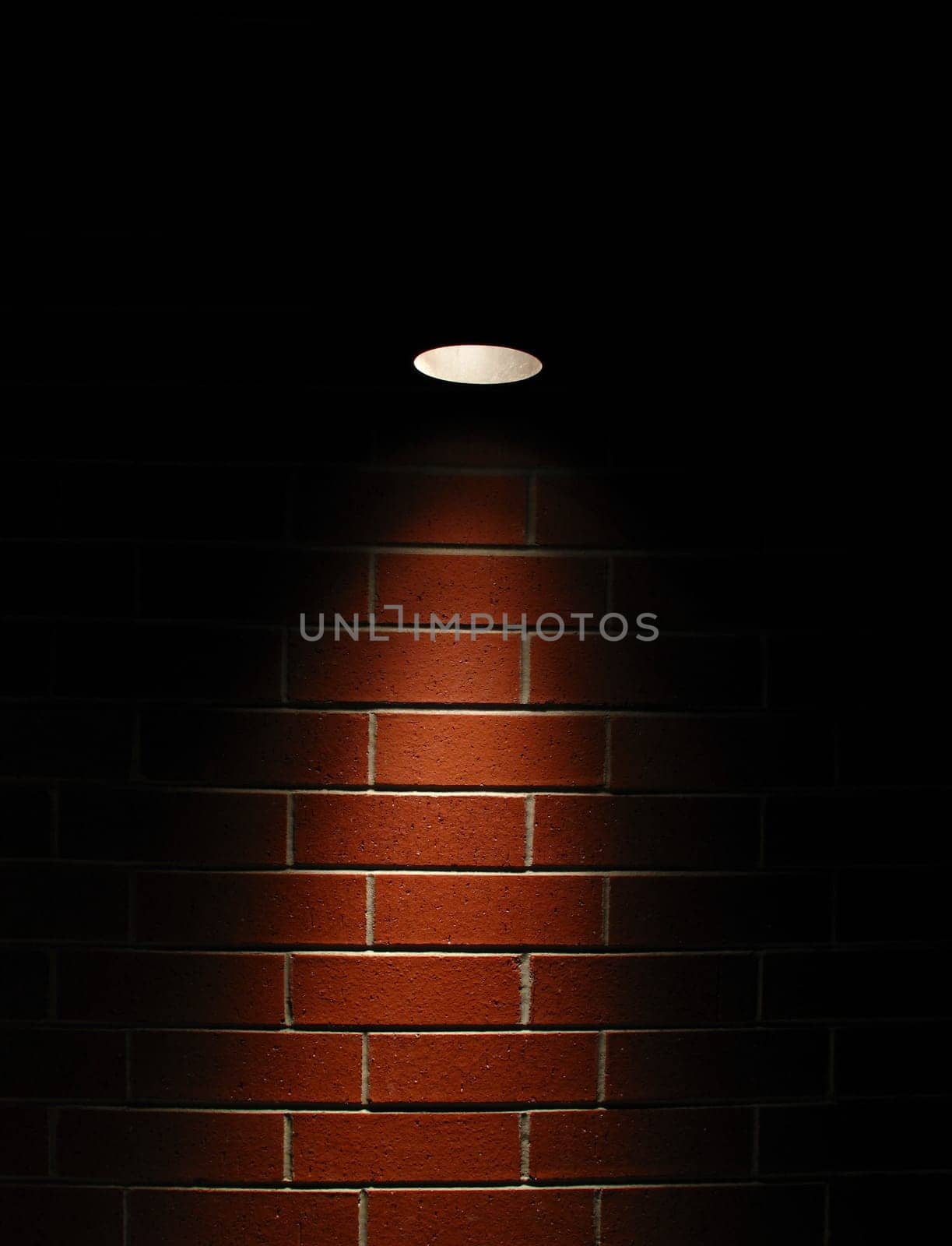 Spotlight on a red brick wall