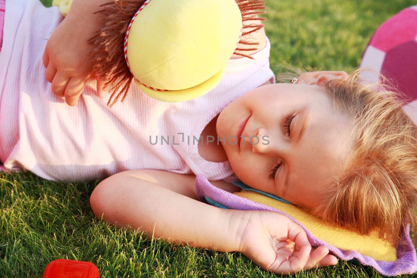 Happy girl relaxing on a grass