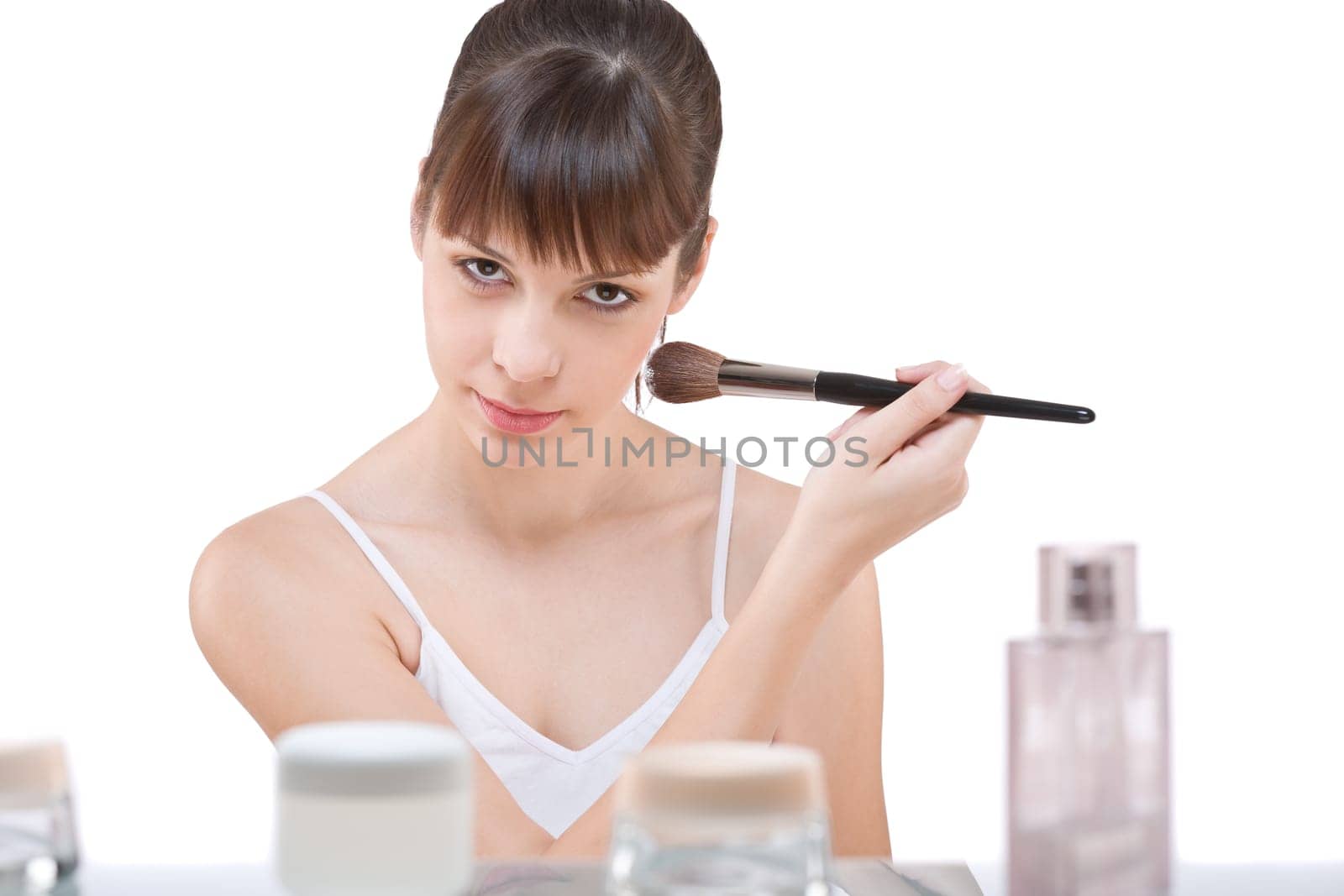 Body care Young woman applying powder with brush