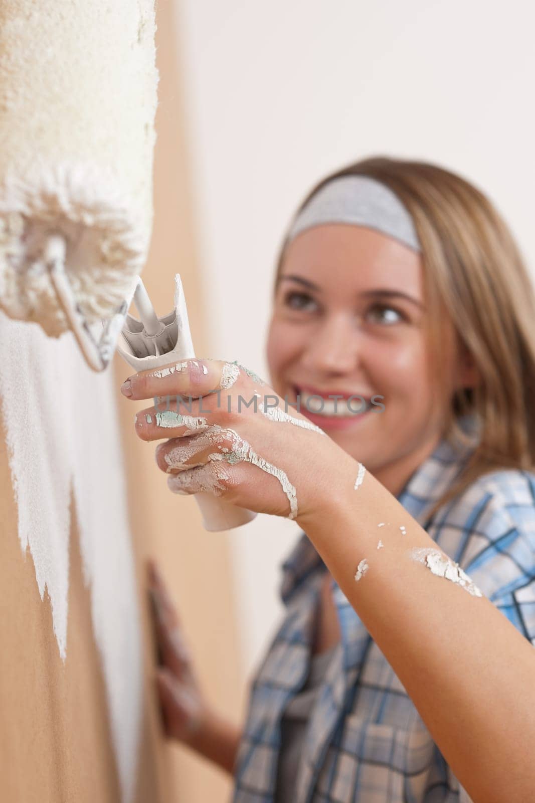Home improvement Young woman with paint roller