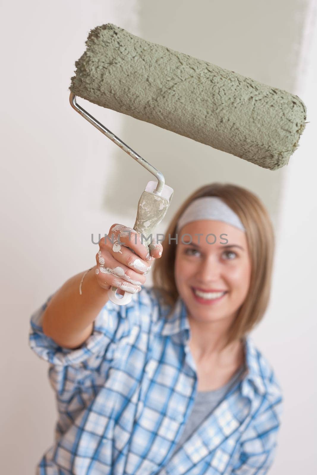 Home improvement Young woman with paint roller