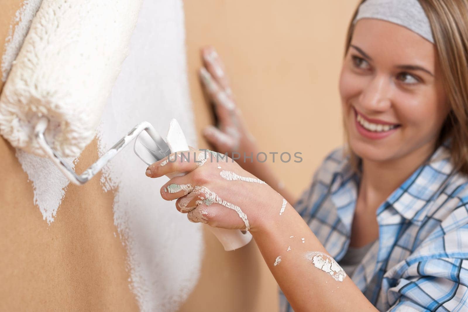 Home improvement Young woman with paint roller
