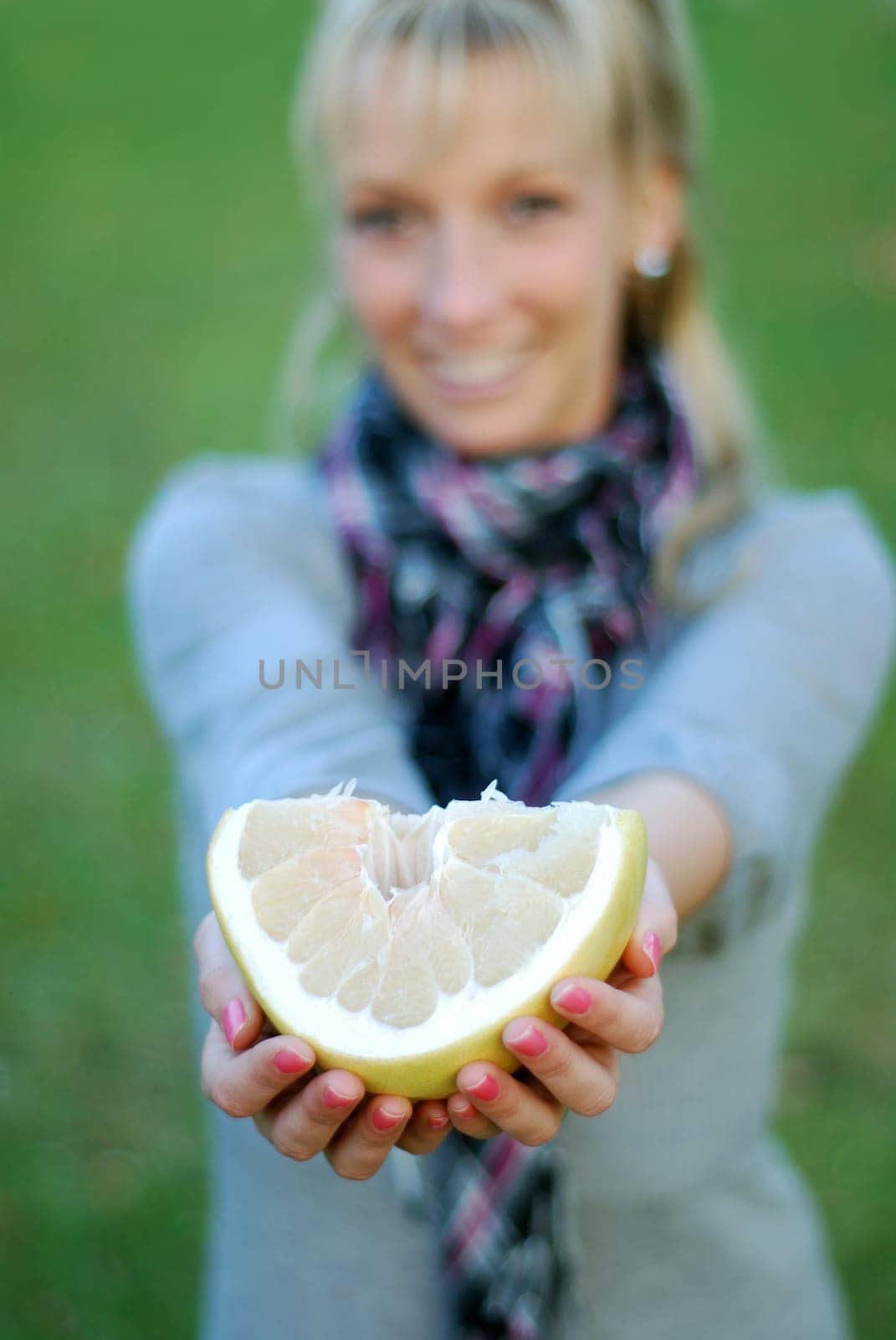 Young woman with pomelo